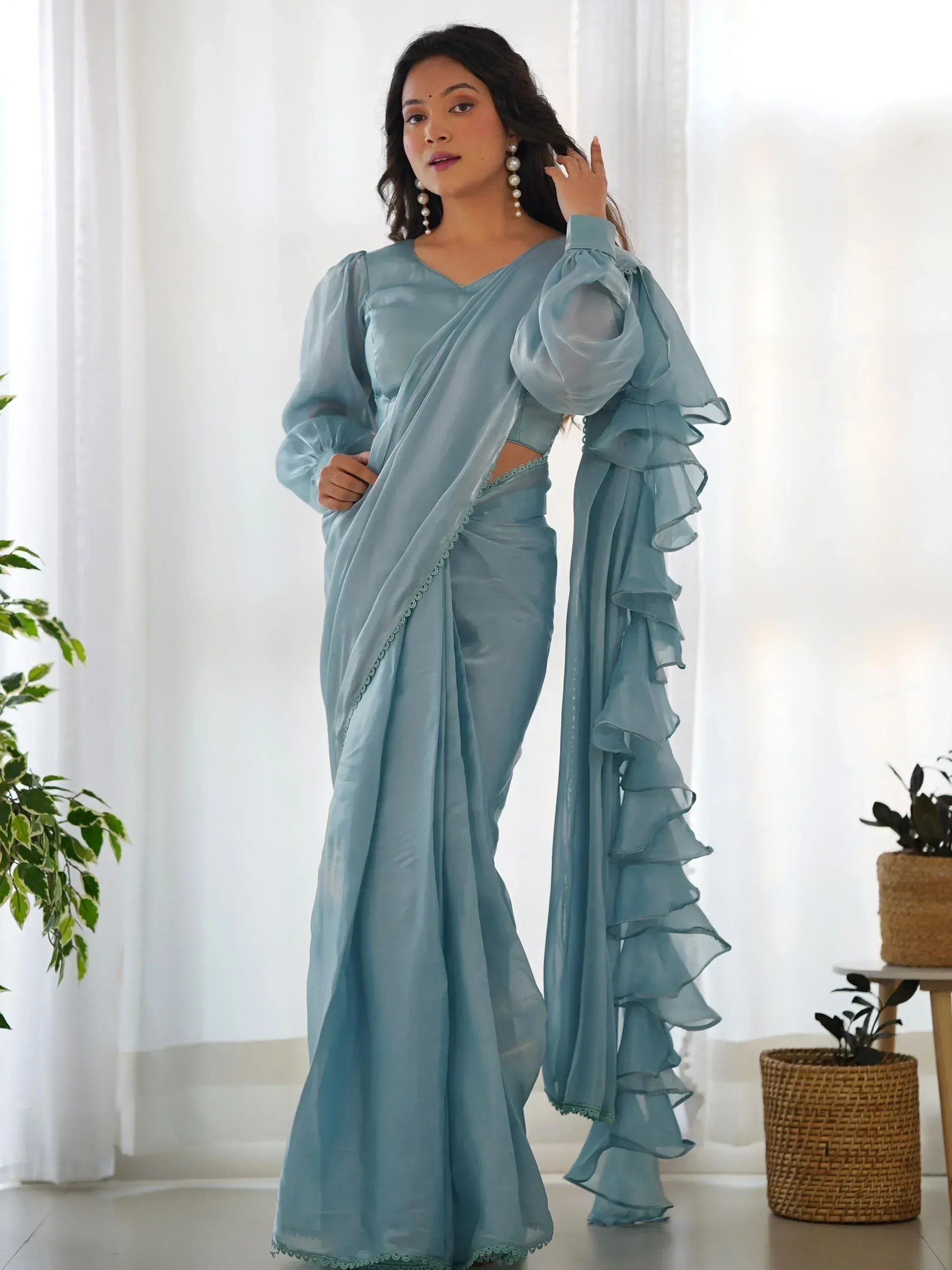 Light blue ethnic saree with ruffled sleeves and scalloped edges, perfect for Indian occasions.
