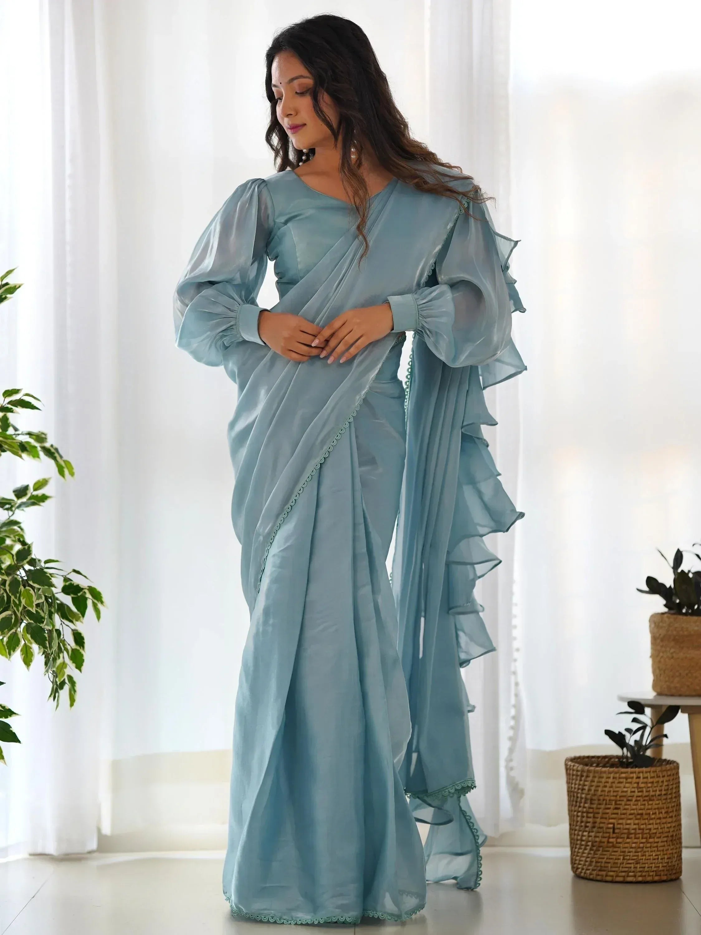Light blue designer saree with ruffled sleeves and scalloped edges, perfect for ethnic occasions
