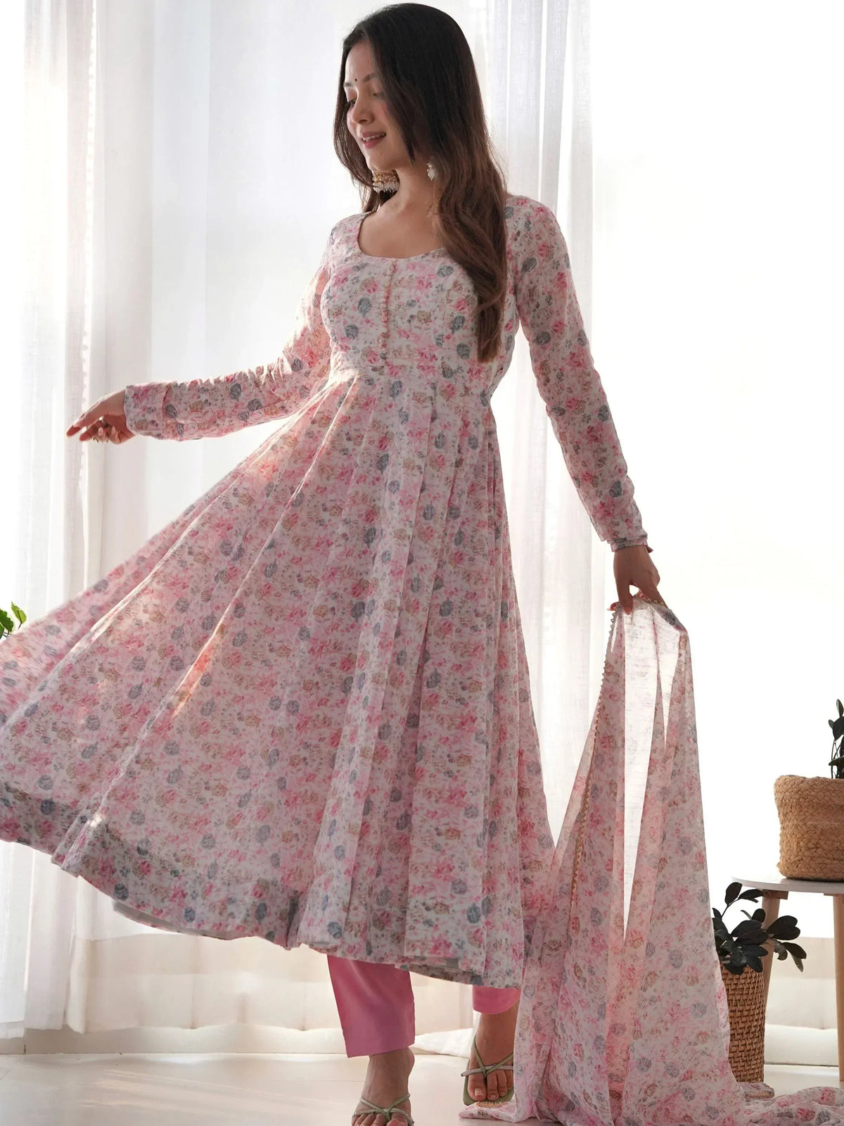Woman in floral print ethnic gown with matching dupatta, ideal for Indian occasions