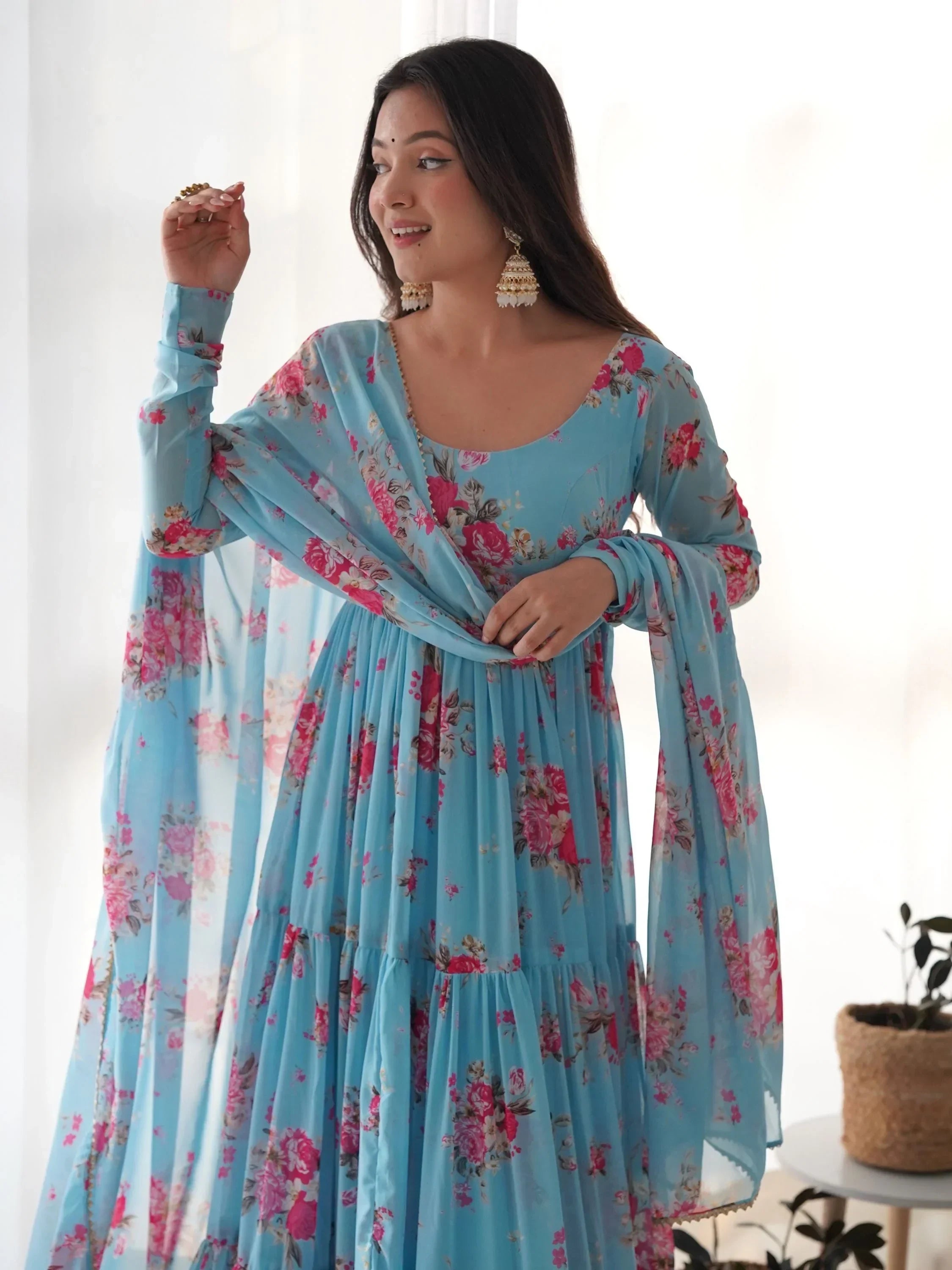 Woman in blue floral printed ethnic gown with dupatta, traditional earrings, Indian fashion