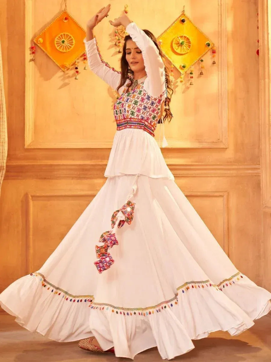 White embroidered ethnic gown with colorful mirror work, perfect for Indian festive occasions and celebrations