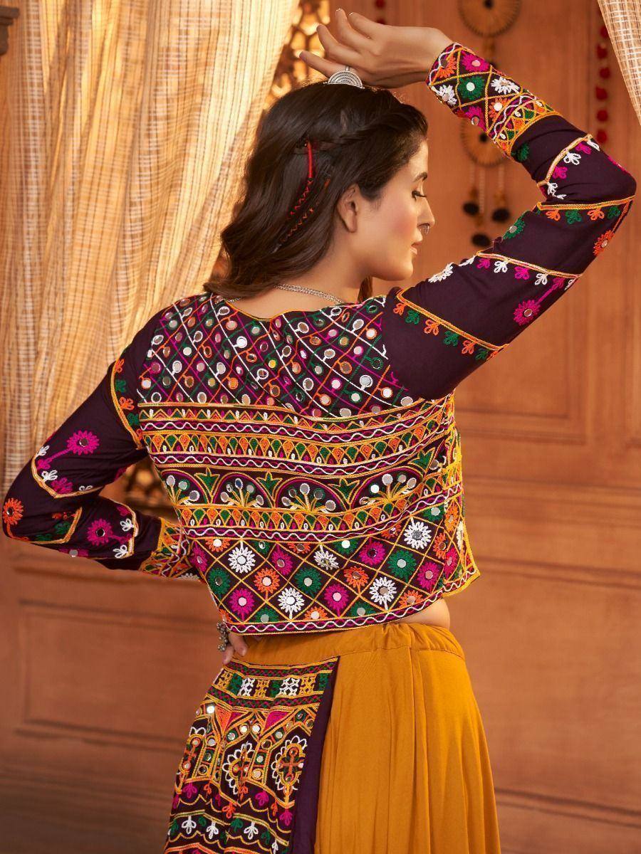 Women's ethnic embroidered blouse with mirror work, paired with mustard skirt, ideal for Indian festive occasions