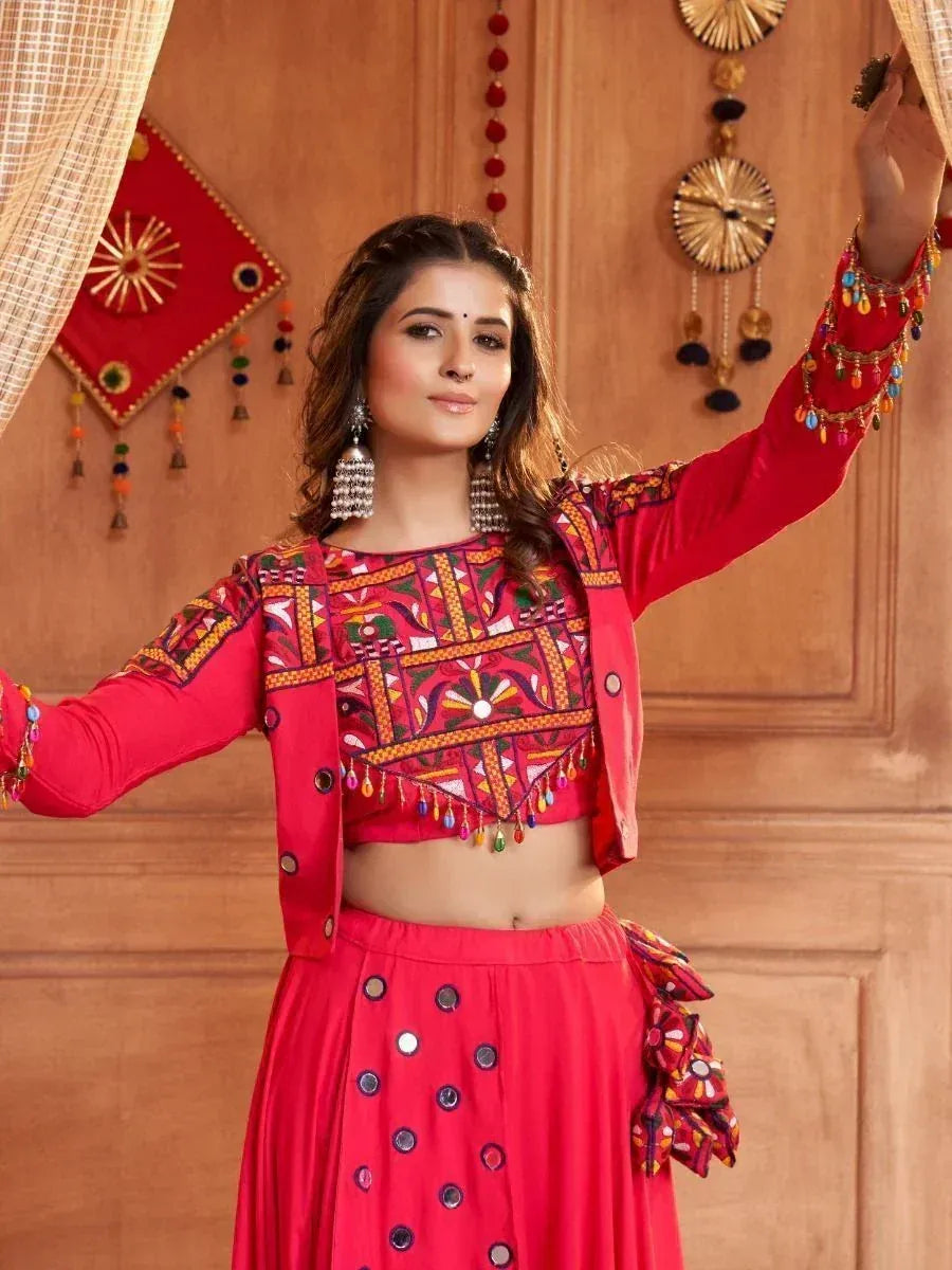 Vibrant red ethnic lehenga choli with mirror work and colorful embroidery, perfect for festive occasions.