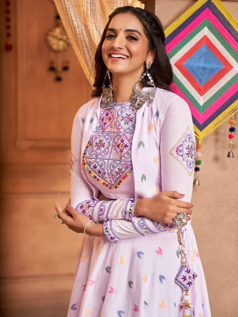 Woman in lavender embroidered ethnic gown with mirror work, perfect for Indian festive occasions