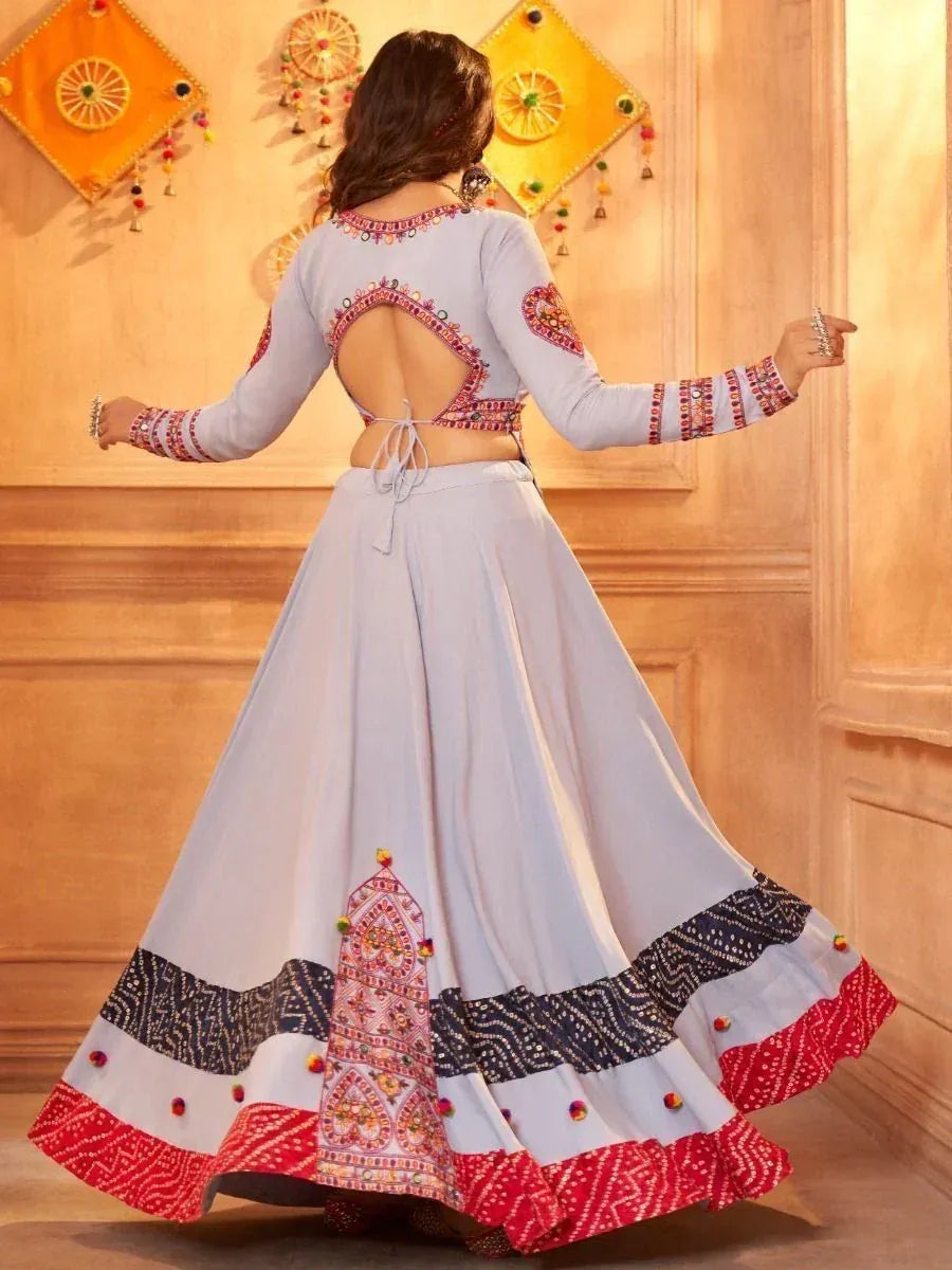 Light blue embroidered lehenga choli with back cutout, colorful border, and mirror work for Indian ethnic wear