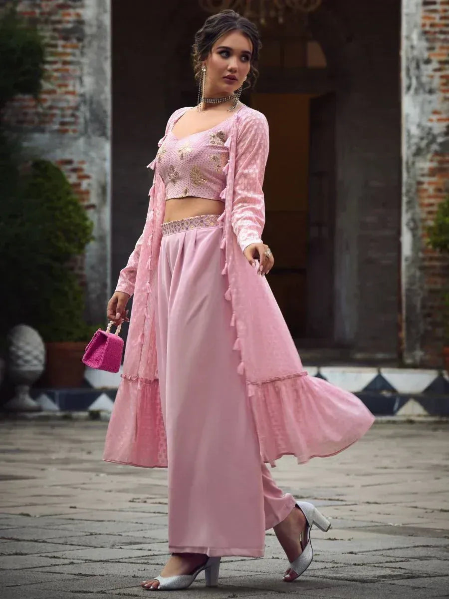 Woman wearing a stylish pink ethnic pant set with long jacket and sequin crop top