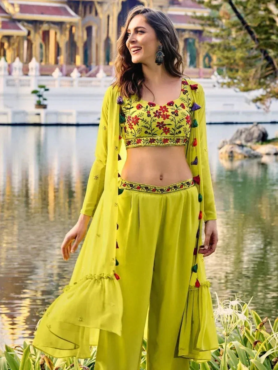 Woman in lime green embroidered crop top and palazzo set with floral patterns, outdoor setting