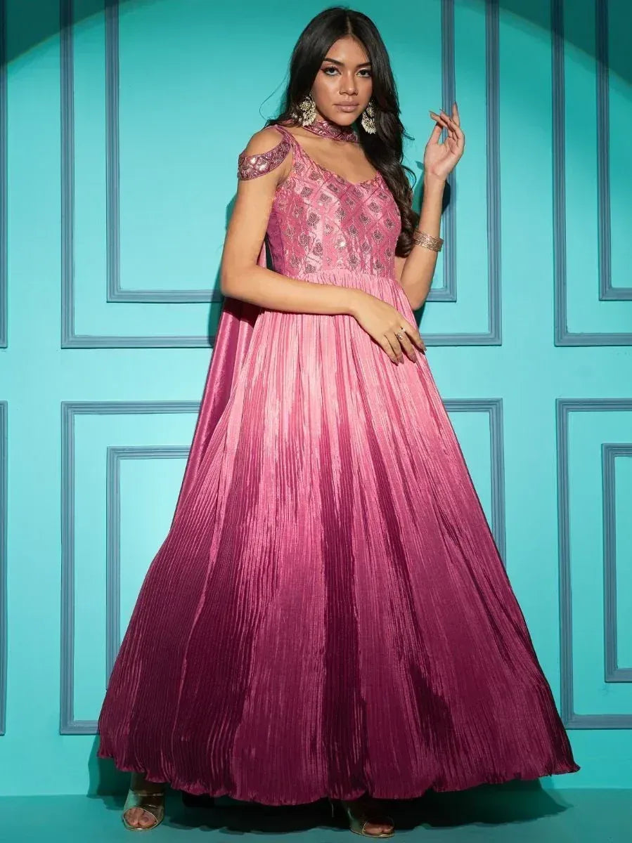 Pink ethnic gown with cold shoulder design and pleated skirt, perfect for Indian festive occasions