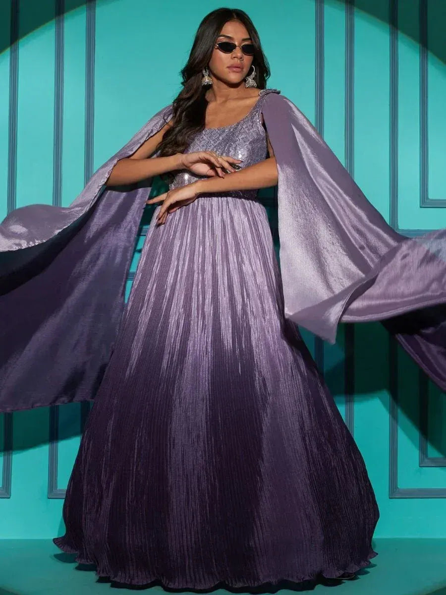 Woman in a stylish purple ethnic gown with flared sleeves, wearing sunglasses and earrings