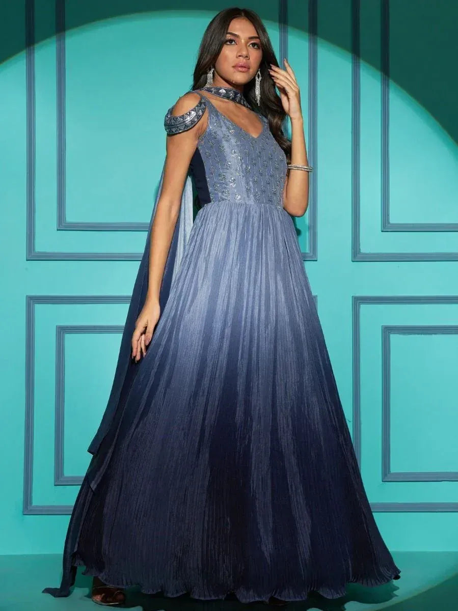 Elegant blue gradient ethnic gown with cold shoulder and cape, perfect for Indian festive occasions.