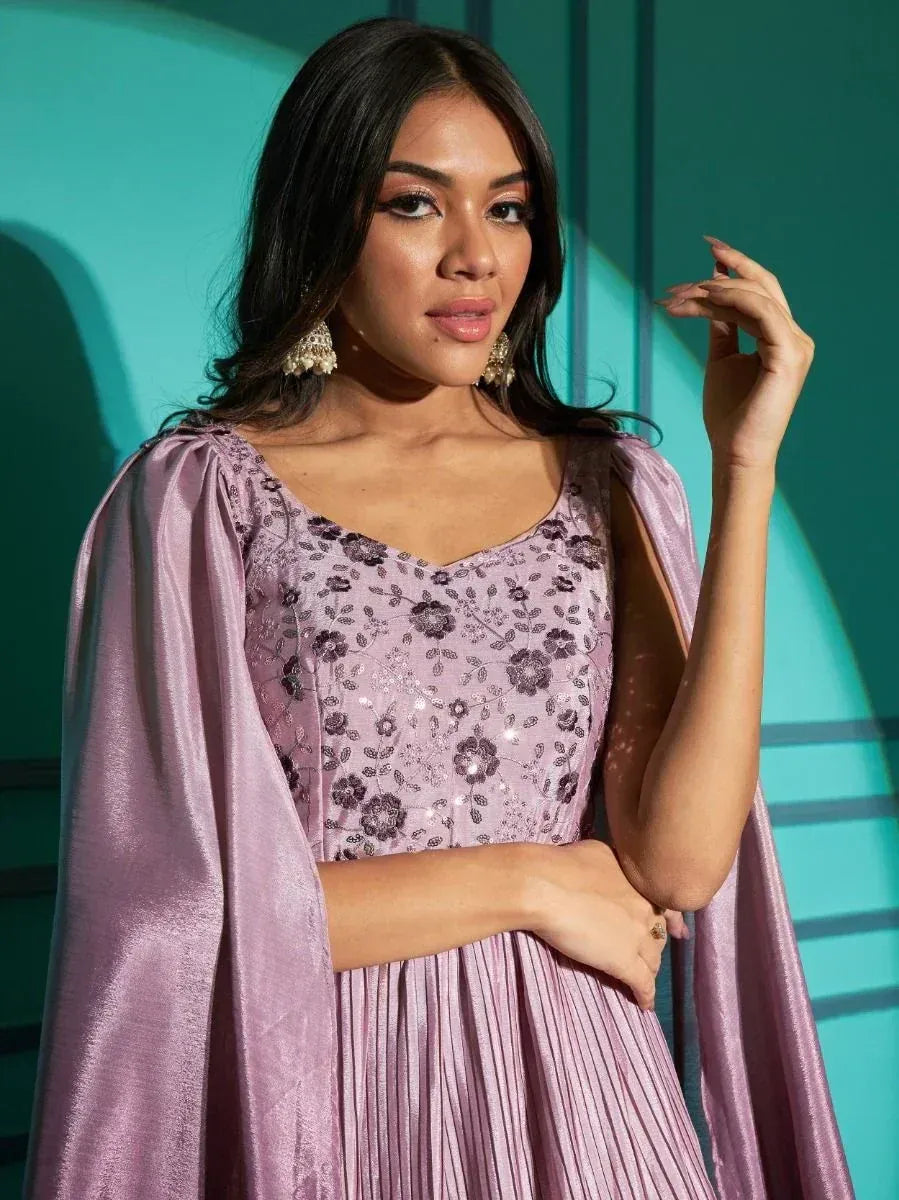 Lavender ethnic gown with floral embroidery and cape sleeves, perfect for Indian festive occasions