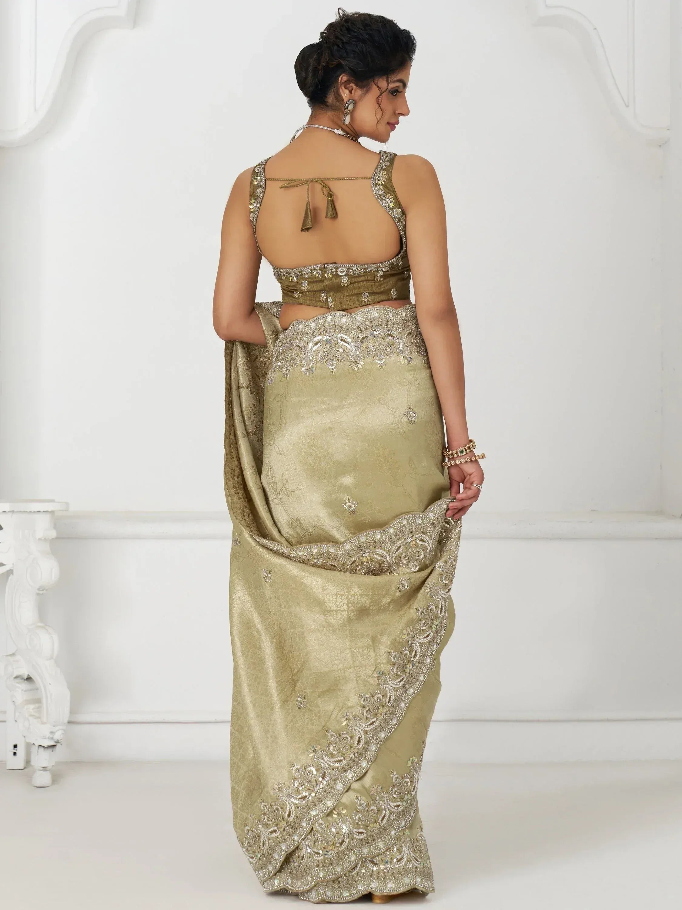 Elegant olive green designer saree with heavy embroidery and backless blouse, perfect for Indian ethnic wear occasions