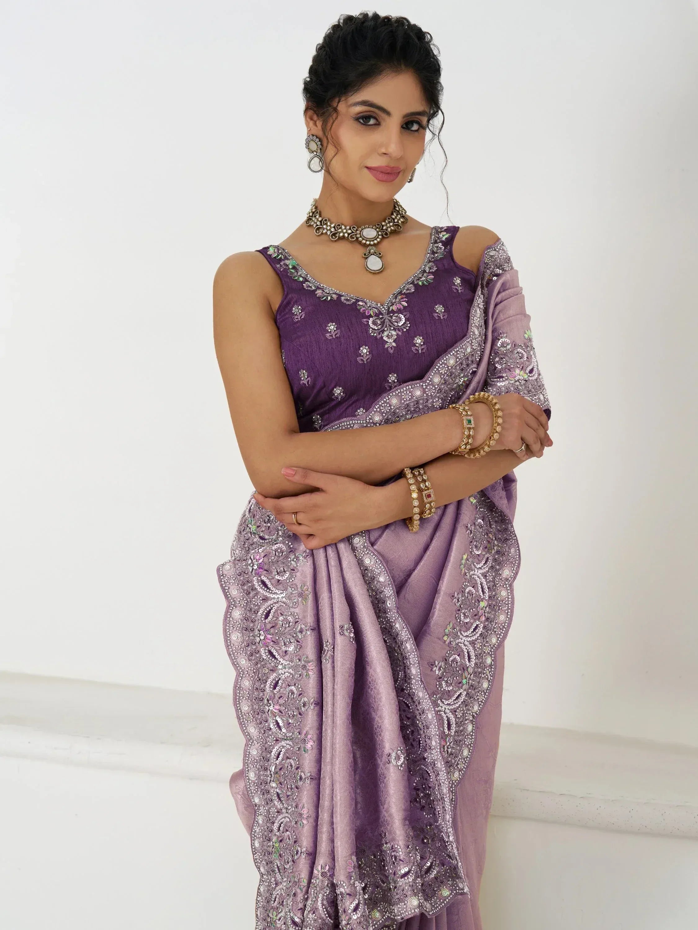 Elegant purple embroidered saree with floral motifs, perfect for Indian ethnic wear occasions.