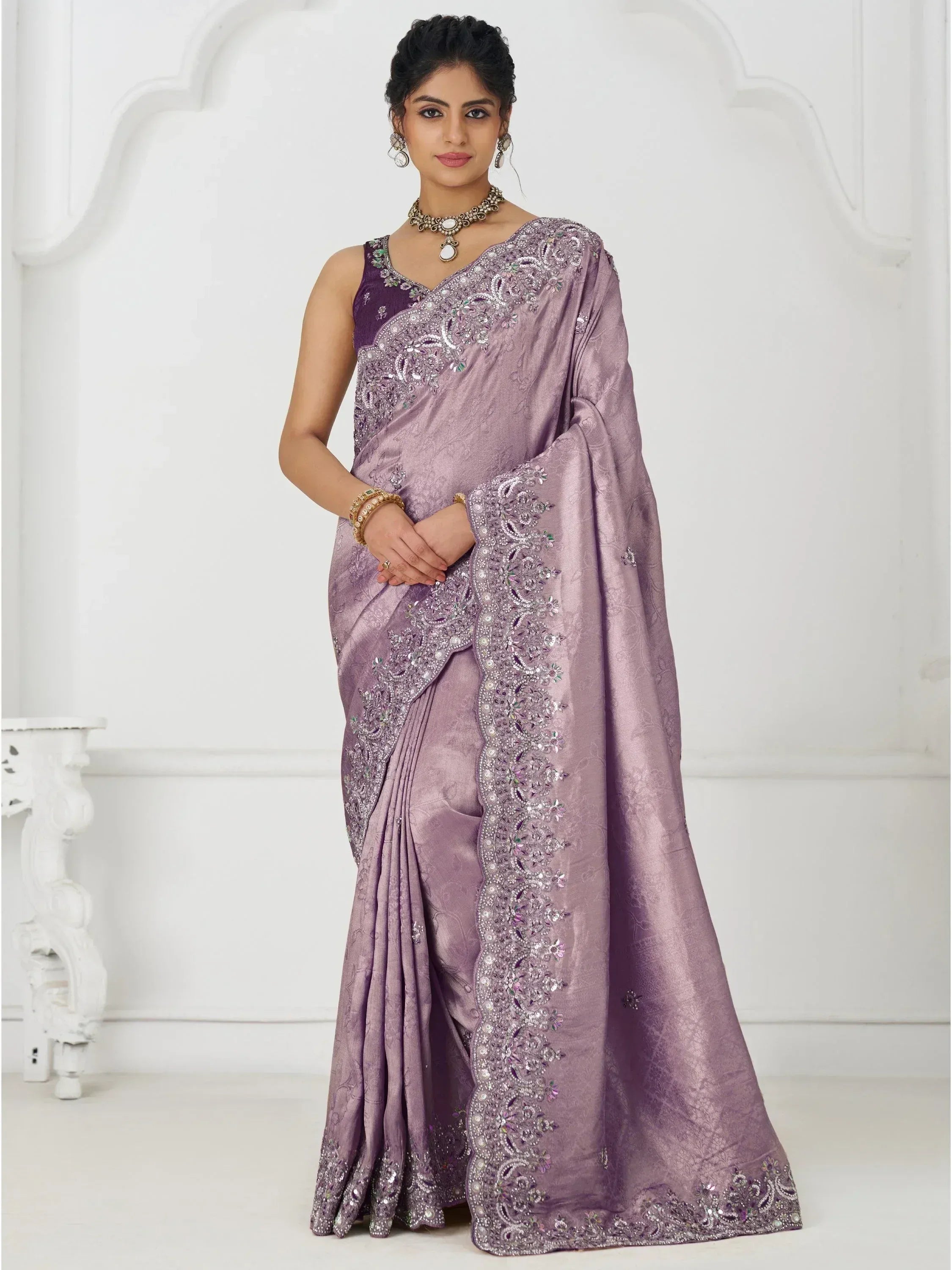 Elegant lavender saree with intricate embroidery and embellished border, perfect for Indian ethnic occasions.