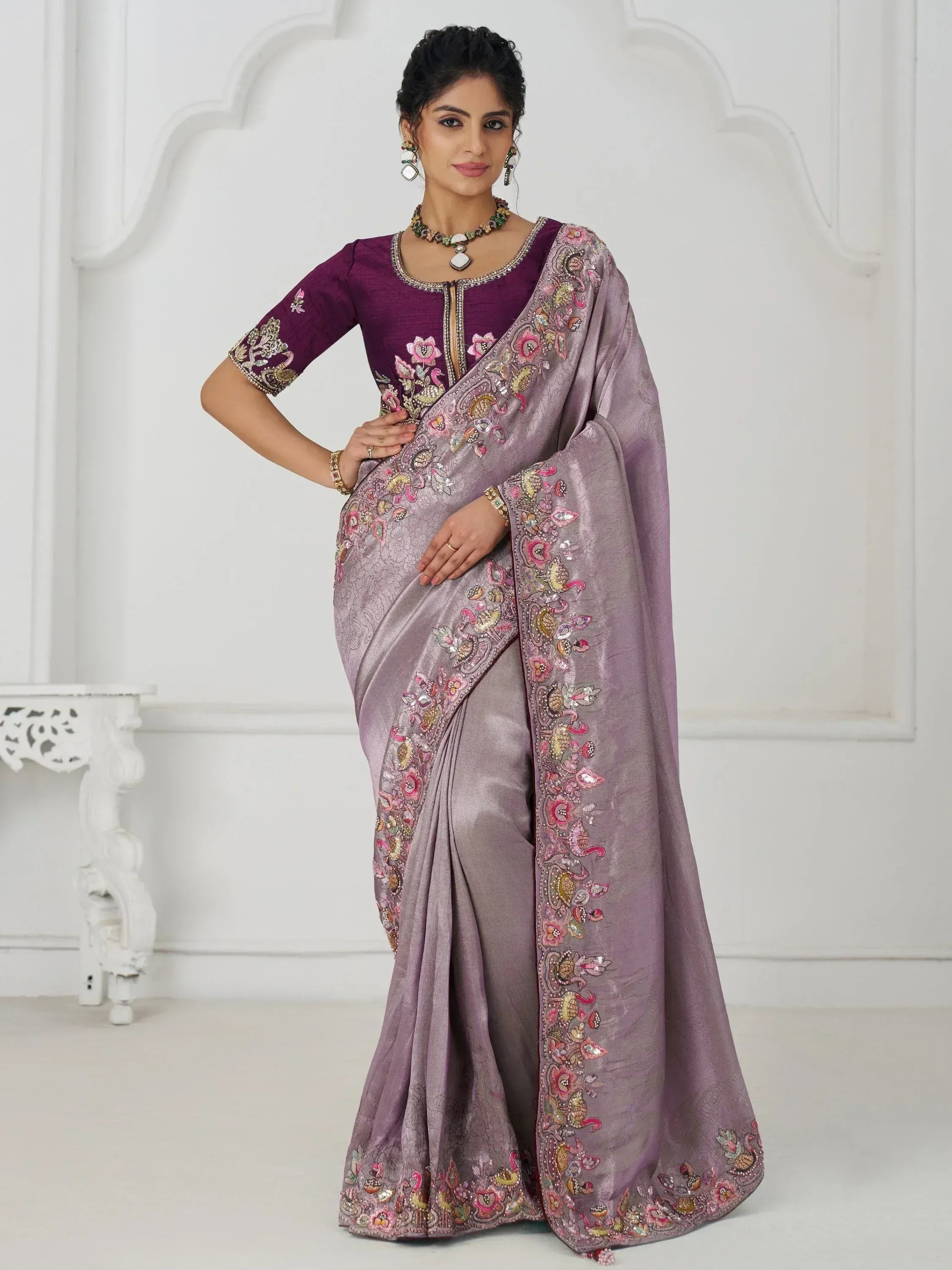 Elegant lavender saree with floral embroidery, paired with a purple blouse, perfect for Indian ethnic occasions.