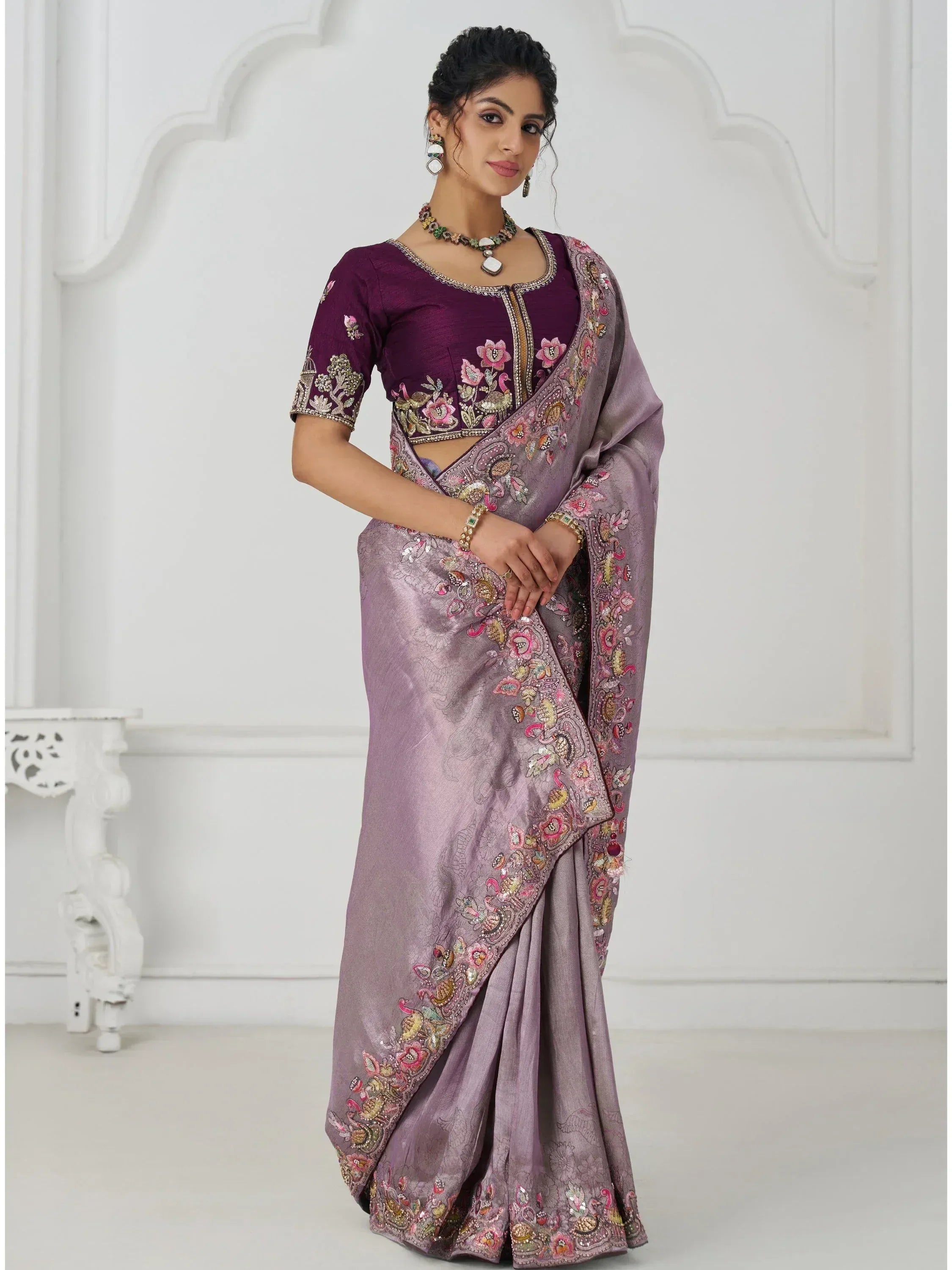 Elegant purple embroidered saree with floral and peacock motifs, perfect for Indian ethnic occasions.