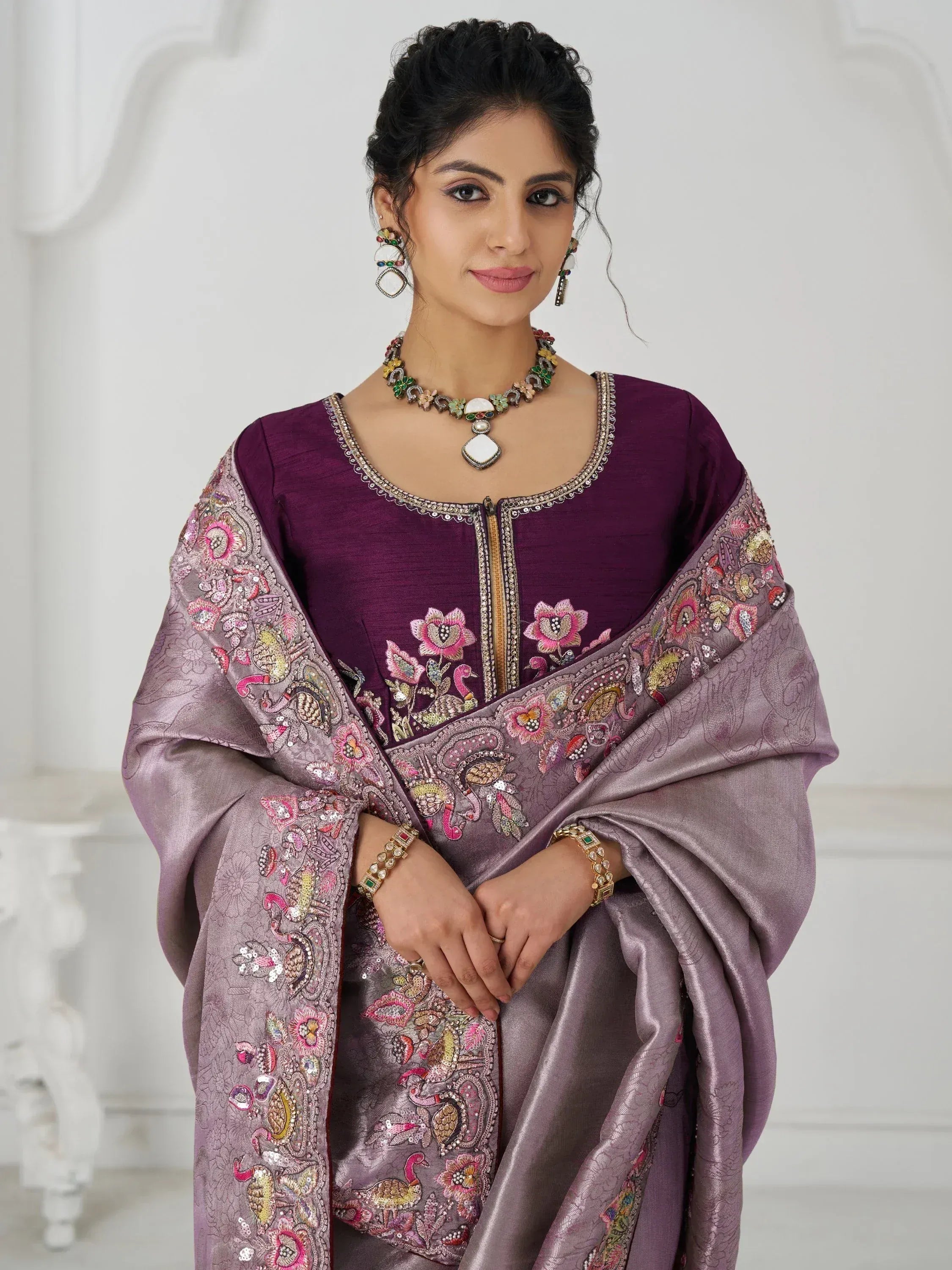 Elegant purple Indian ethnic wear with floral embroidery and matching dupatta, perfect for festive occasions.