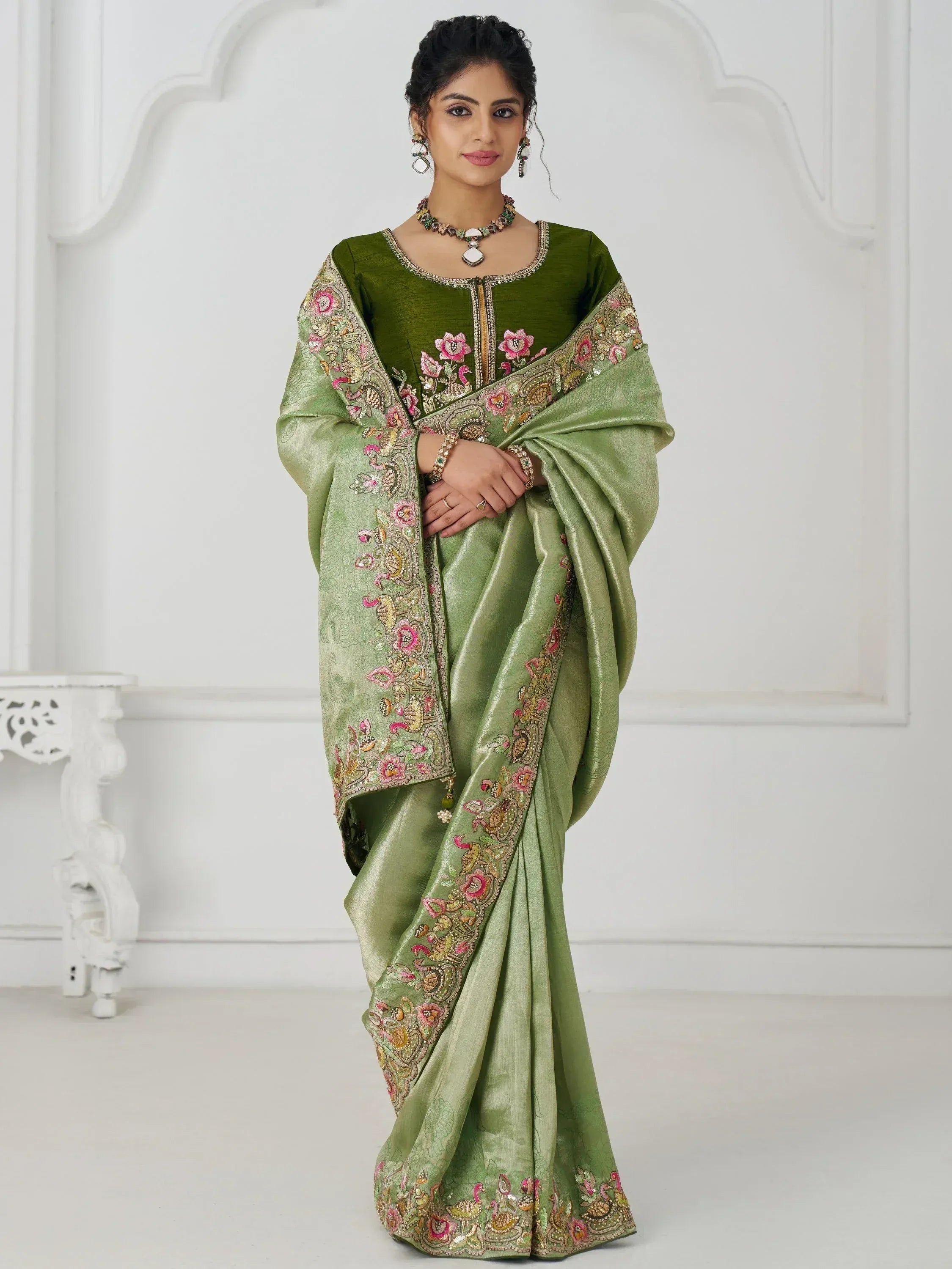 Green embroidered saree with floral and peacock motifs, perfect for Indian ethnic occasions