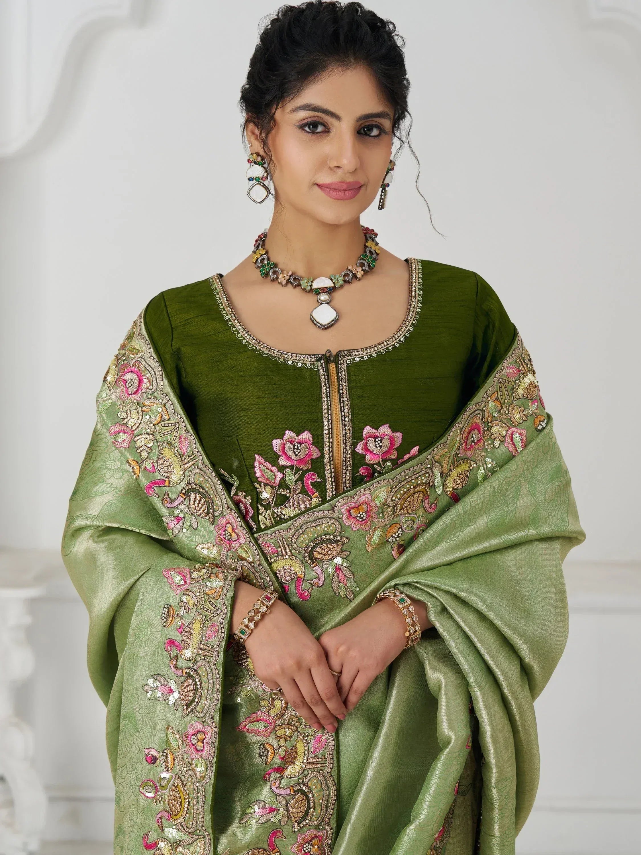 Olive green embroidered salwar kameez with floral and peacock motifs, perfect for Indian ethnic wear occasions.