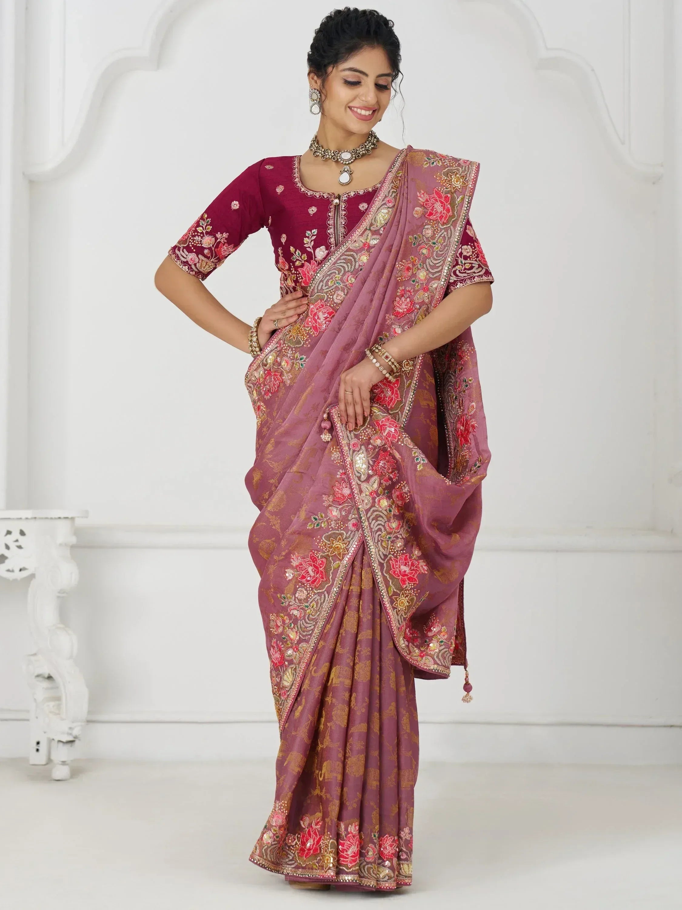 Woman in maroon embroidered saree with floral gold detailing, perfect for Indian ethnic occasions