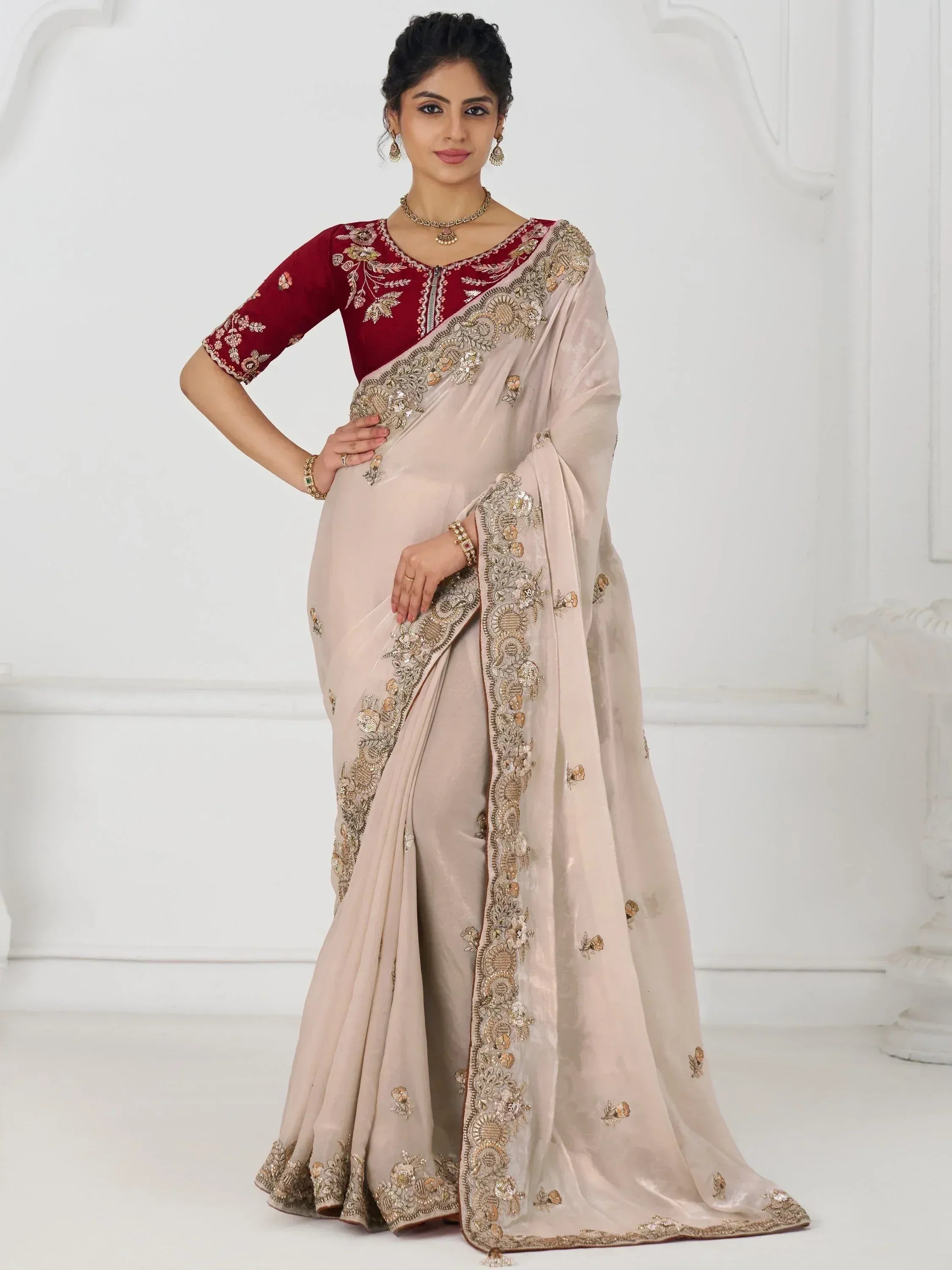 Elegant beige saree with gold embroidery and maroon blouse, perfect for Indian ethnic occasions