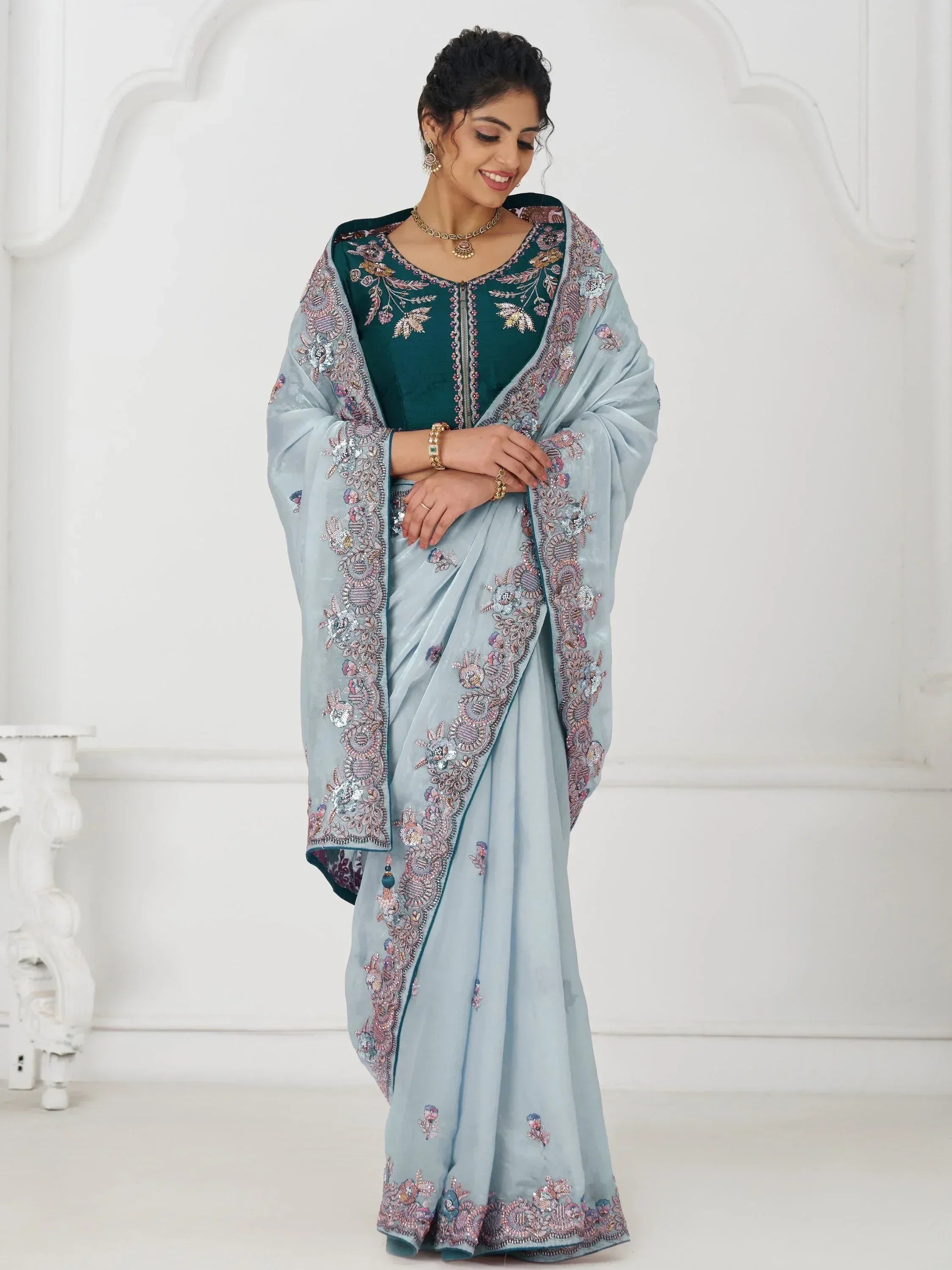 Light blue embroidered saree with teal blouse, perfect for Indian ethnic wear occasions