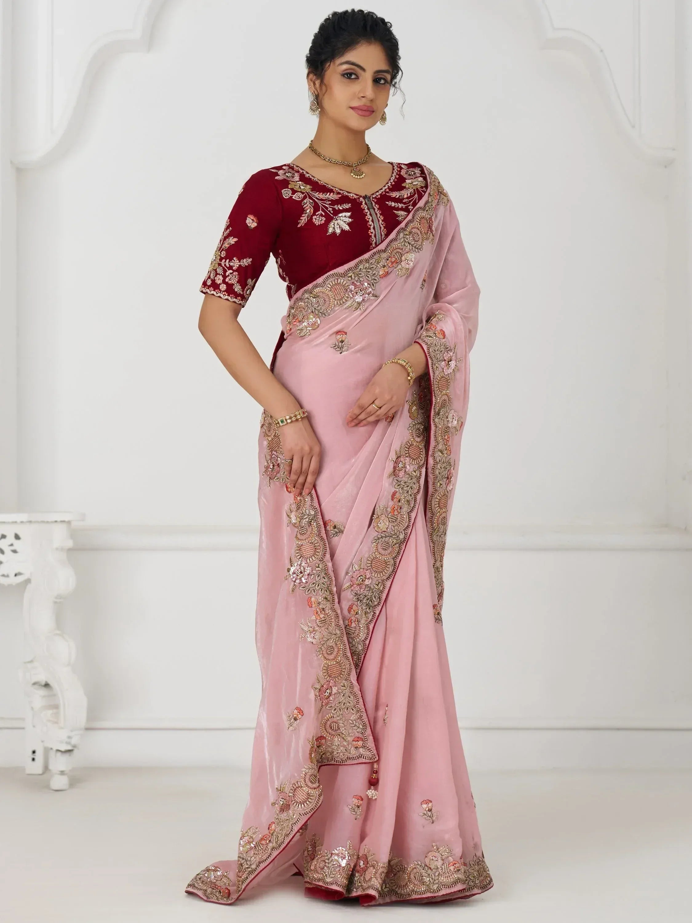 Pink velvet saree with maroon blouse, floral embroidery, and gold detailing for Indian ethnic wear