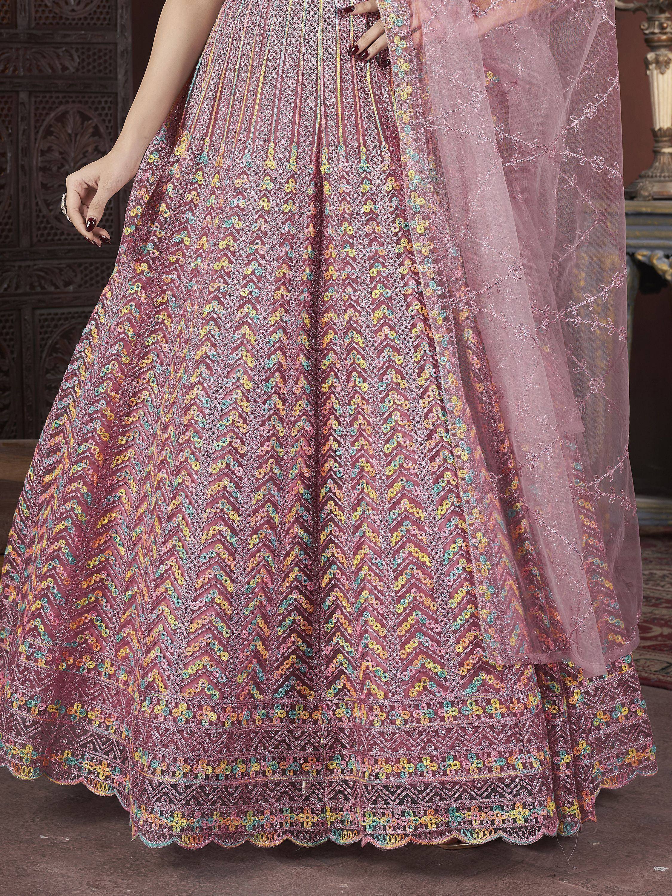 Pink embroidered lehenga with colorful floral patterns and sheer dupatta, perfect for Indian ethnic wear