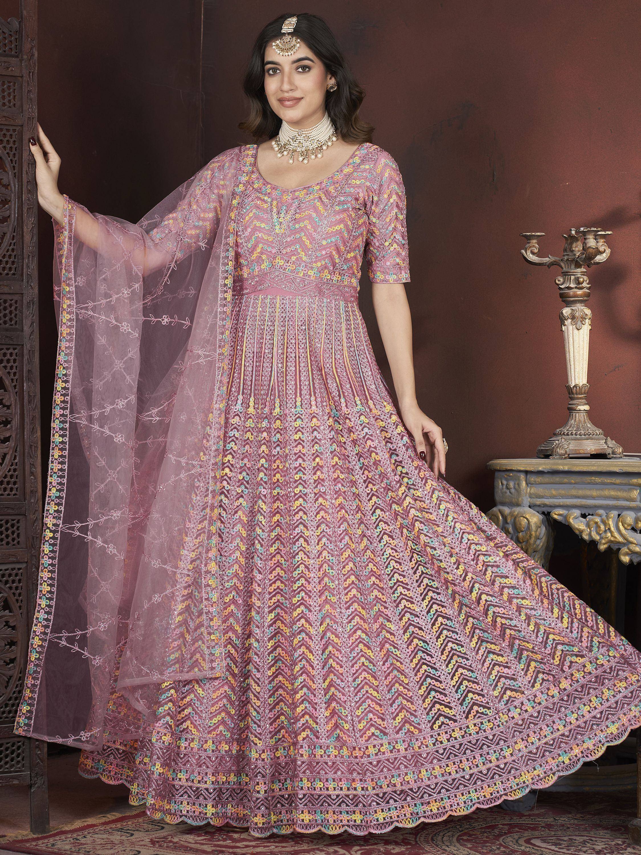Elegant pink anarkali with colorful geometric embroidery, paired with sheer dupatta for festive occasions.