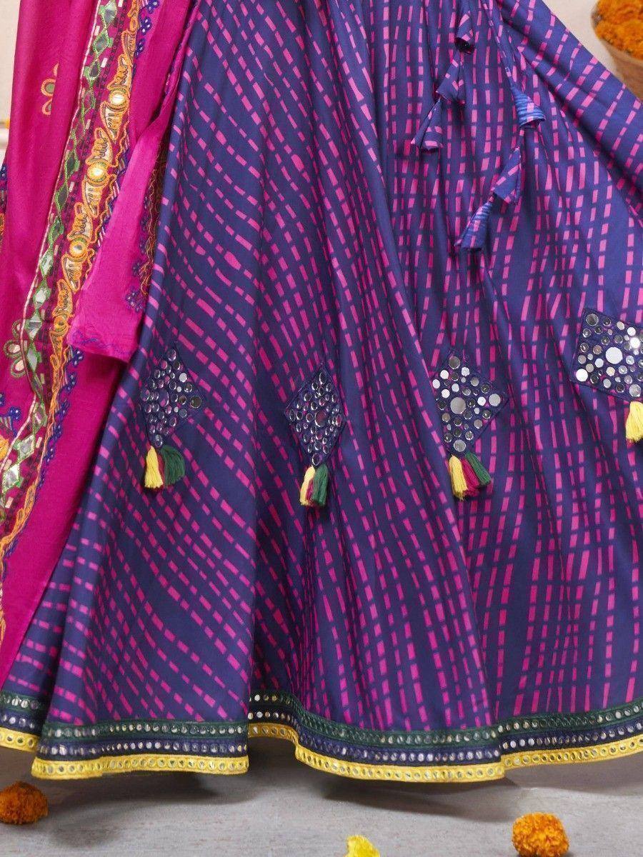 Purple and pink ethnic lehenga with mirror work, tassels, and embroidered dupatta for Indian occasions