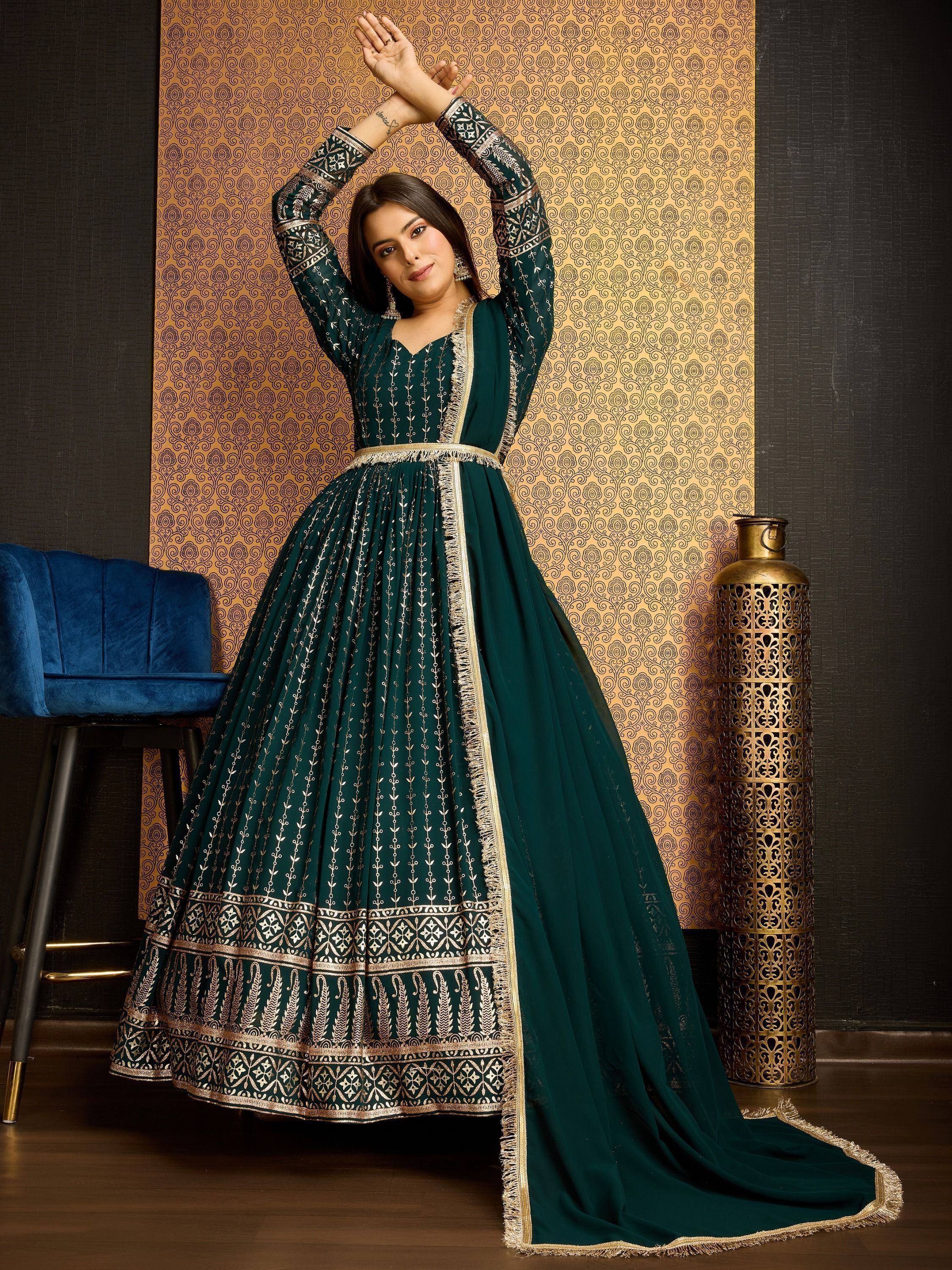 Emerald green ethnic gown with gold embroidery, perfect for Indian weddings and festive occasions.
