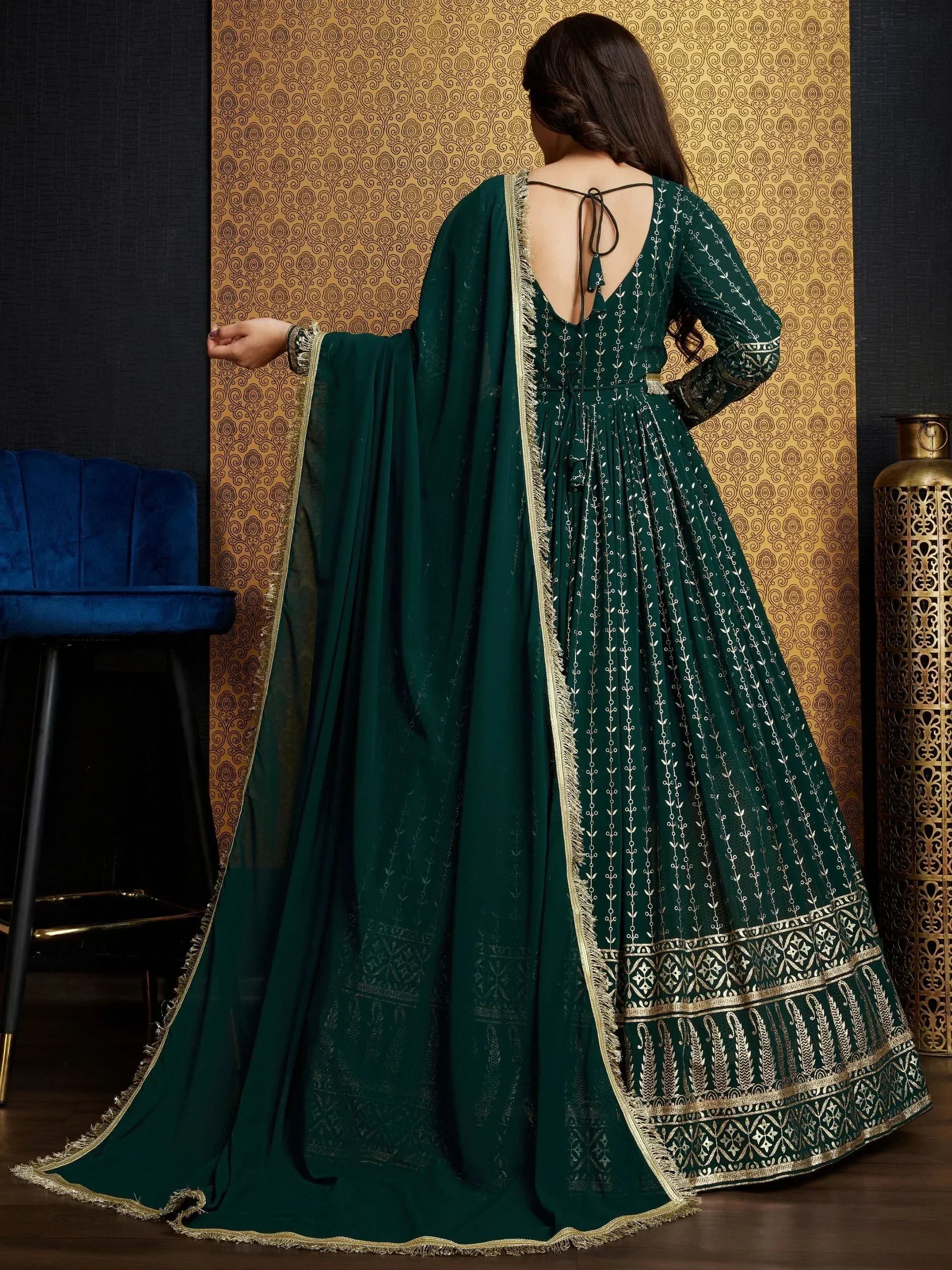 Emerald green embroidered anarkali gown with gold detailing and back tie, perfect for Indian ethnic occasions.