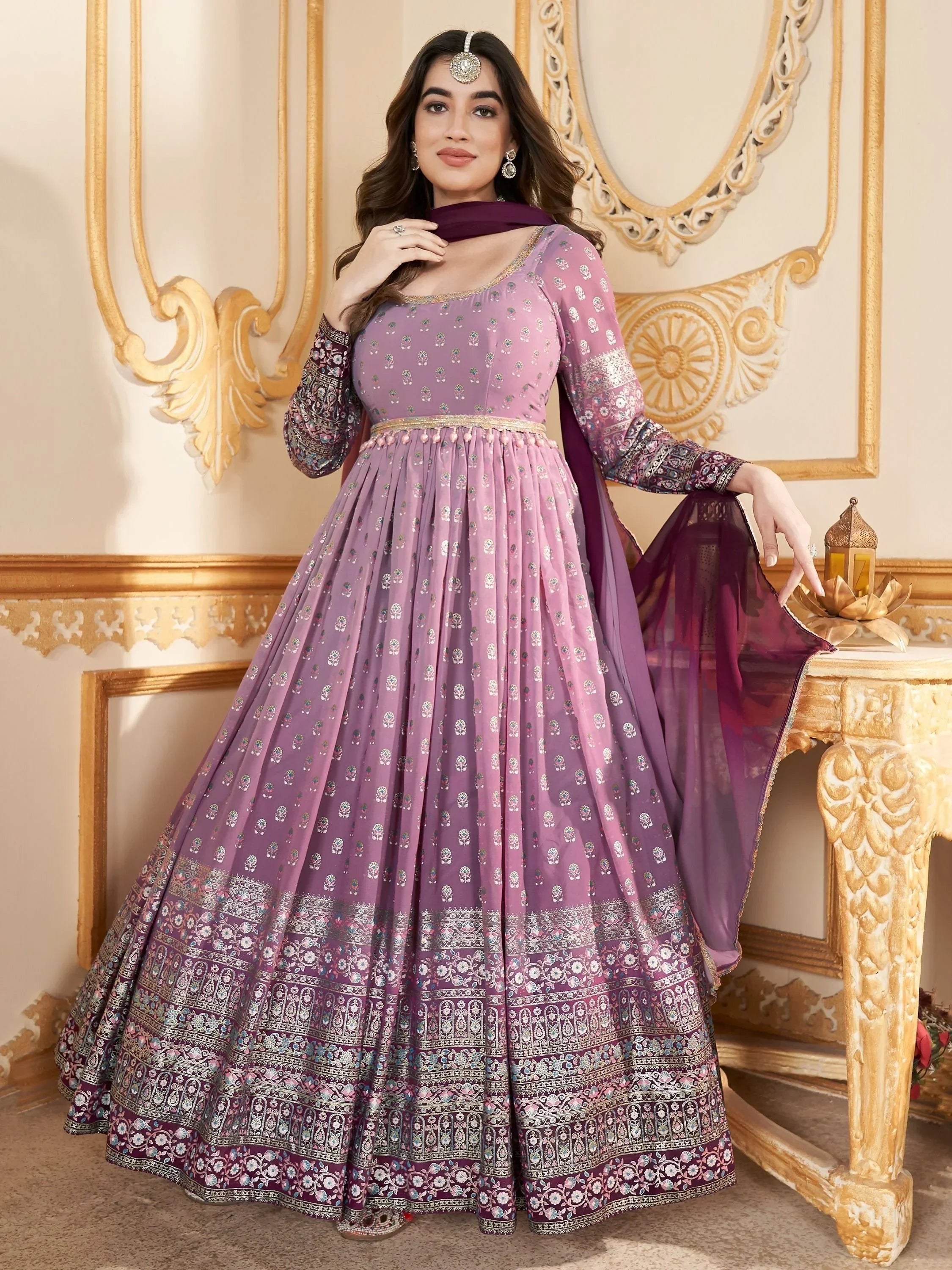 Woman wearing lavender embroidered Anarkali gown with dupatta, traditional Indian ethnic wear