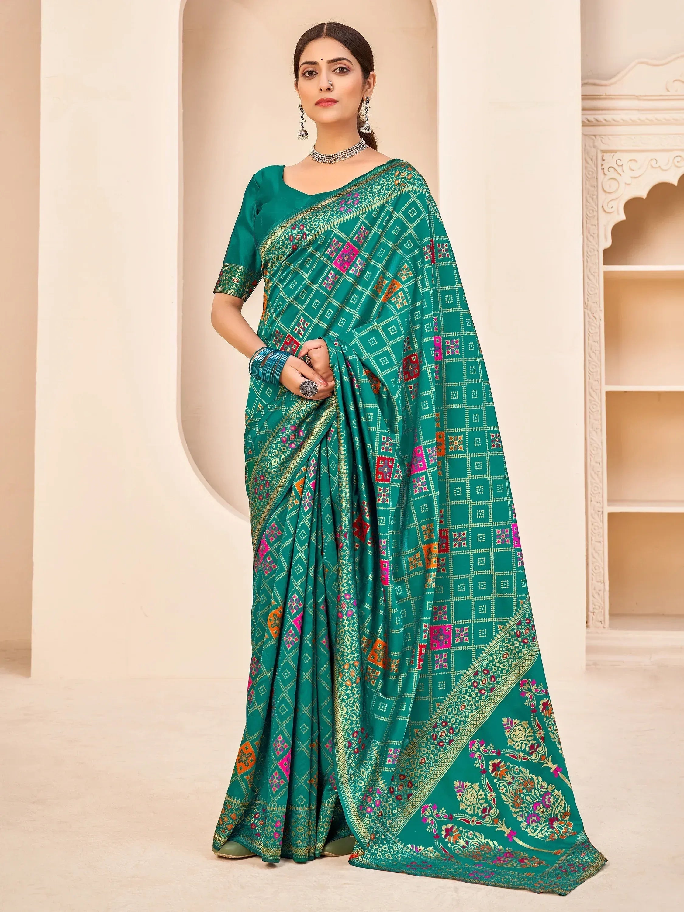 Emerald green ethnic saree with colorful geometric and floral prints, perfect for Indian occasions.