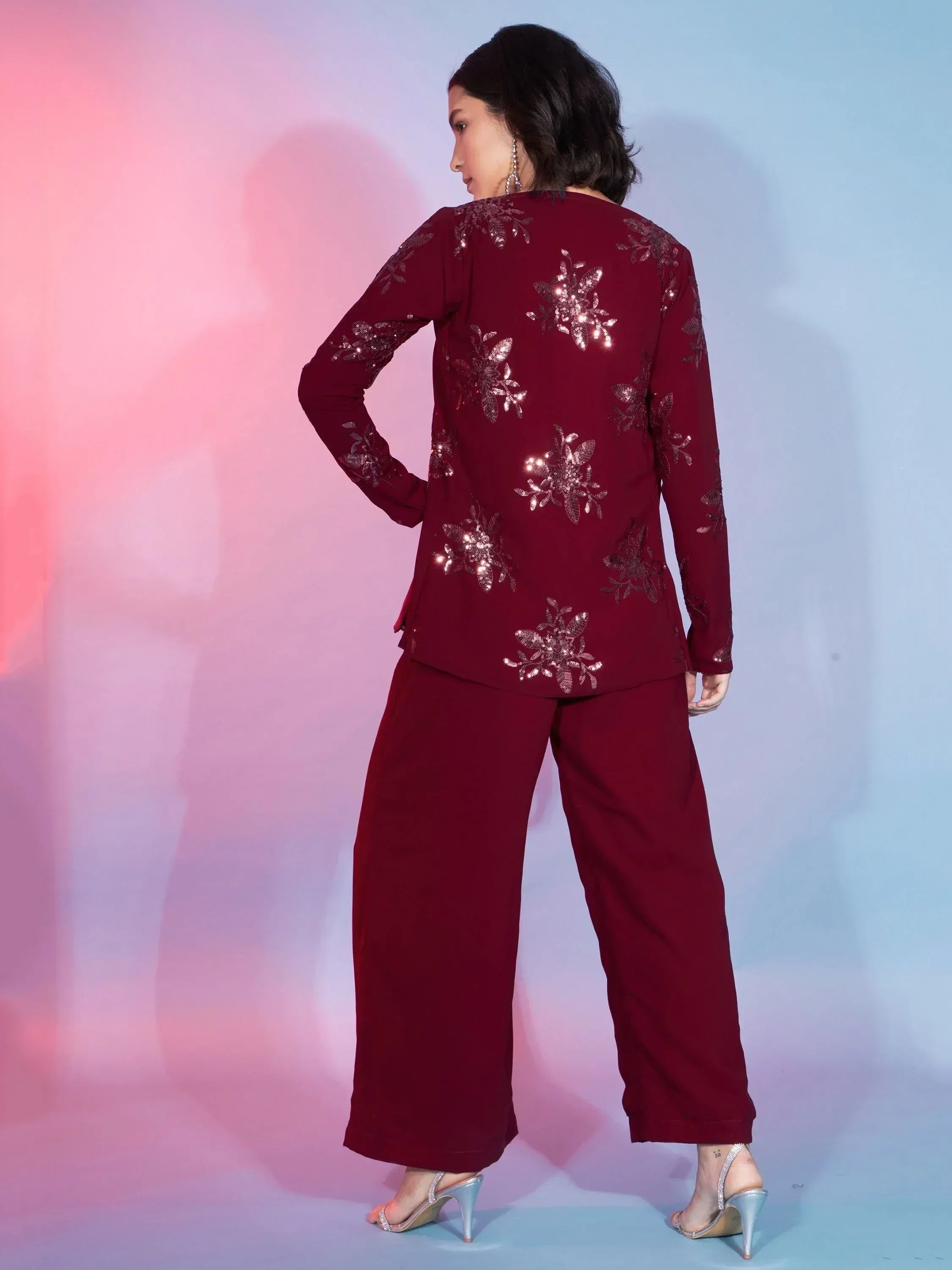 Maroon ethnic suit with sequin floral embroidery, wide-leg pants, and silver heels for festive occasions