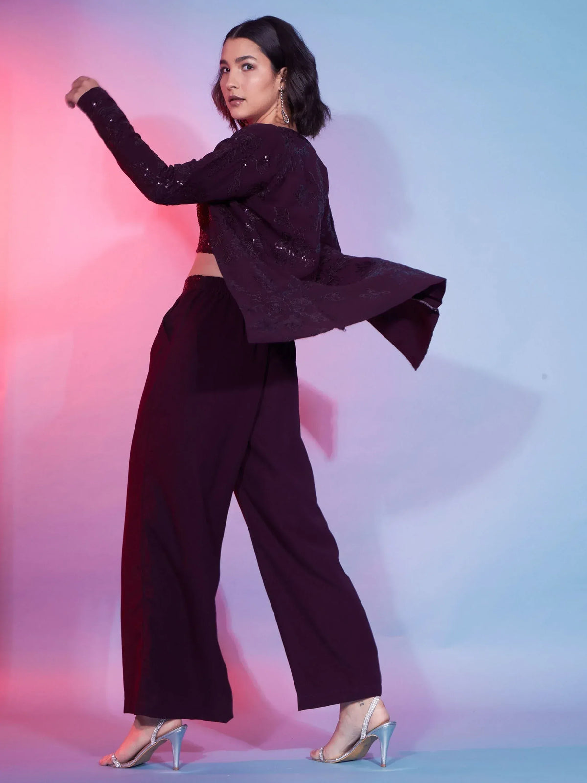 Woman in maroon sequin crop top and wide-leg pants, ethnic party wear outfit