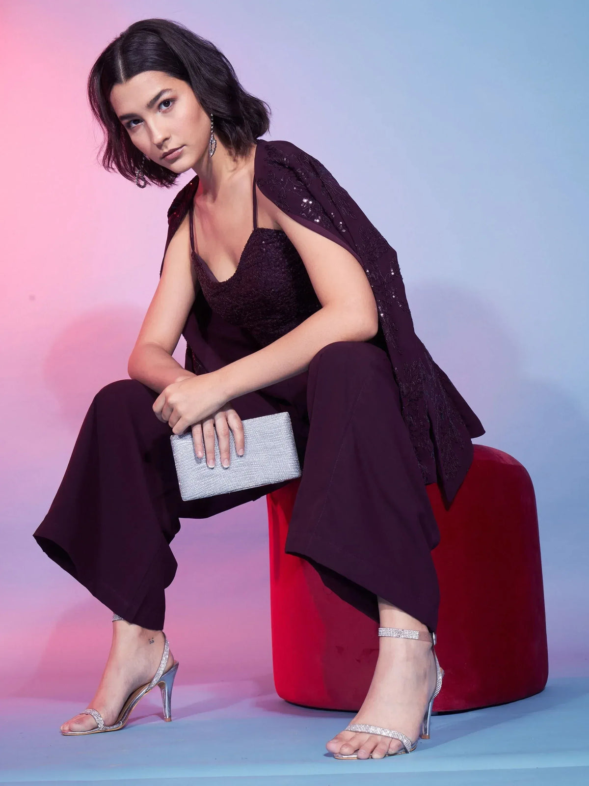 Elegant maroon ethnic gown with sequin cape, paired with silver heels and clutch for festive occasions