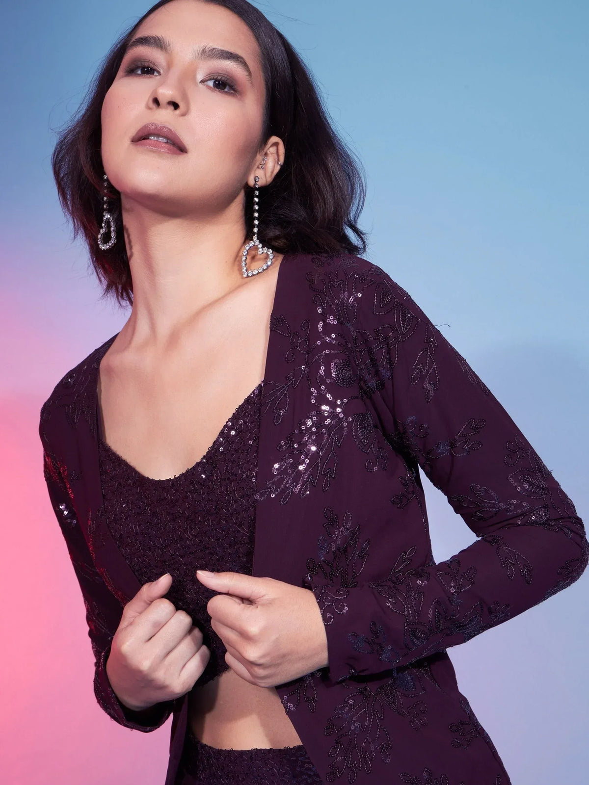 Elegant purple sequin ethnic gown with floral embroidery, perfect for Indian festive occasions.