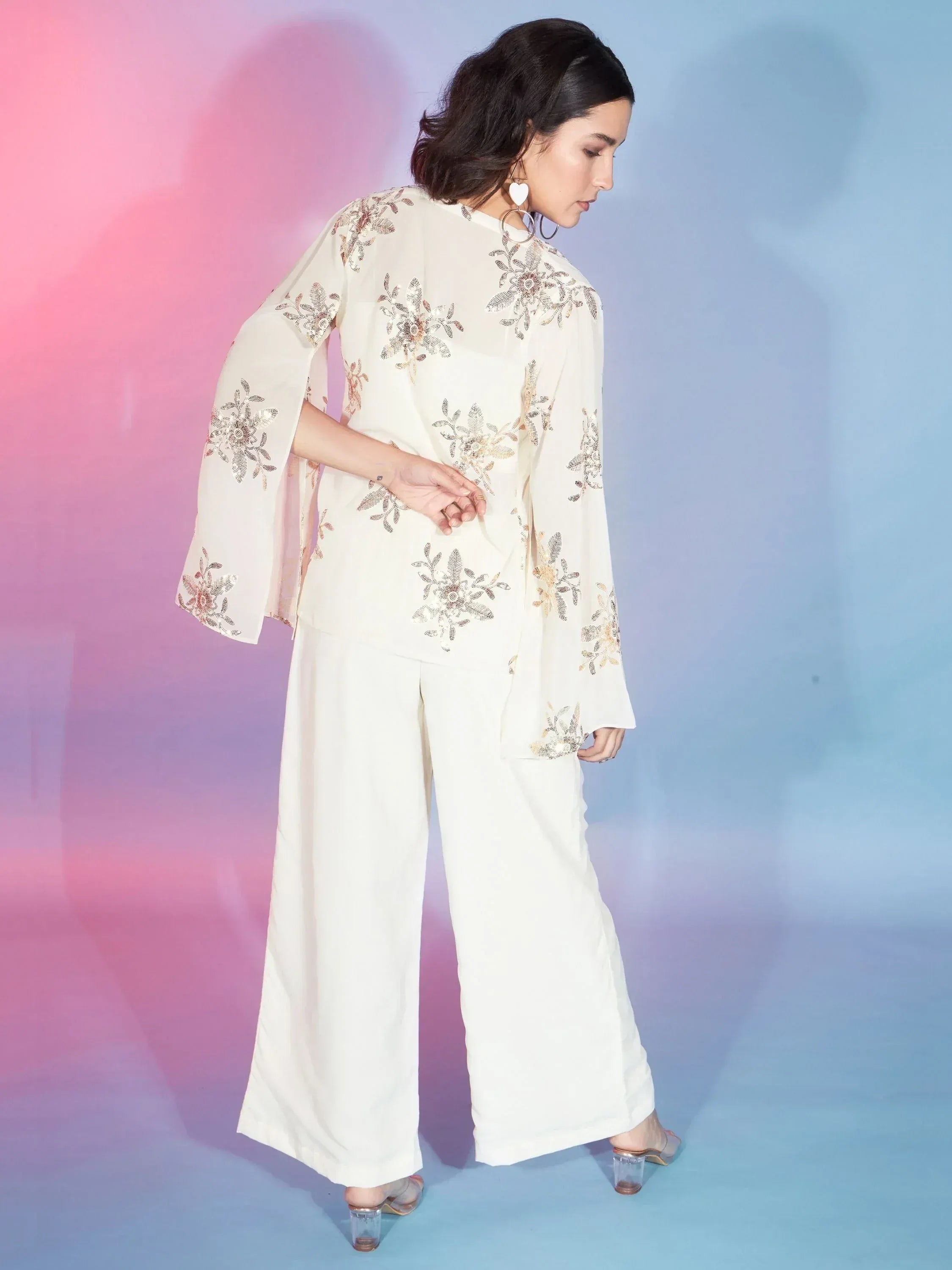 Cream embroidered ethnic suit with floral motifs and wide-leg pants, perfect for Indian occasions