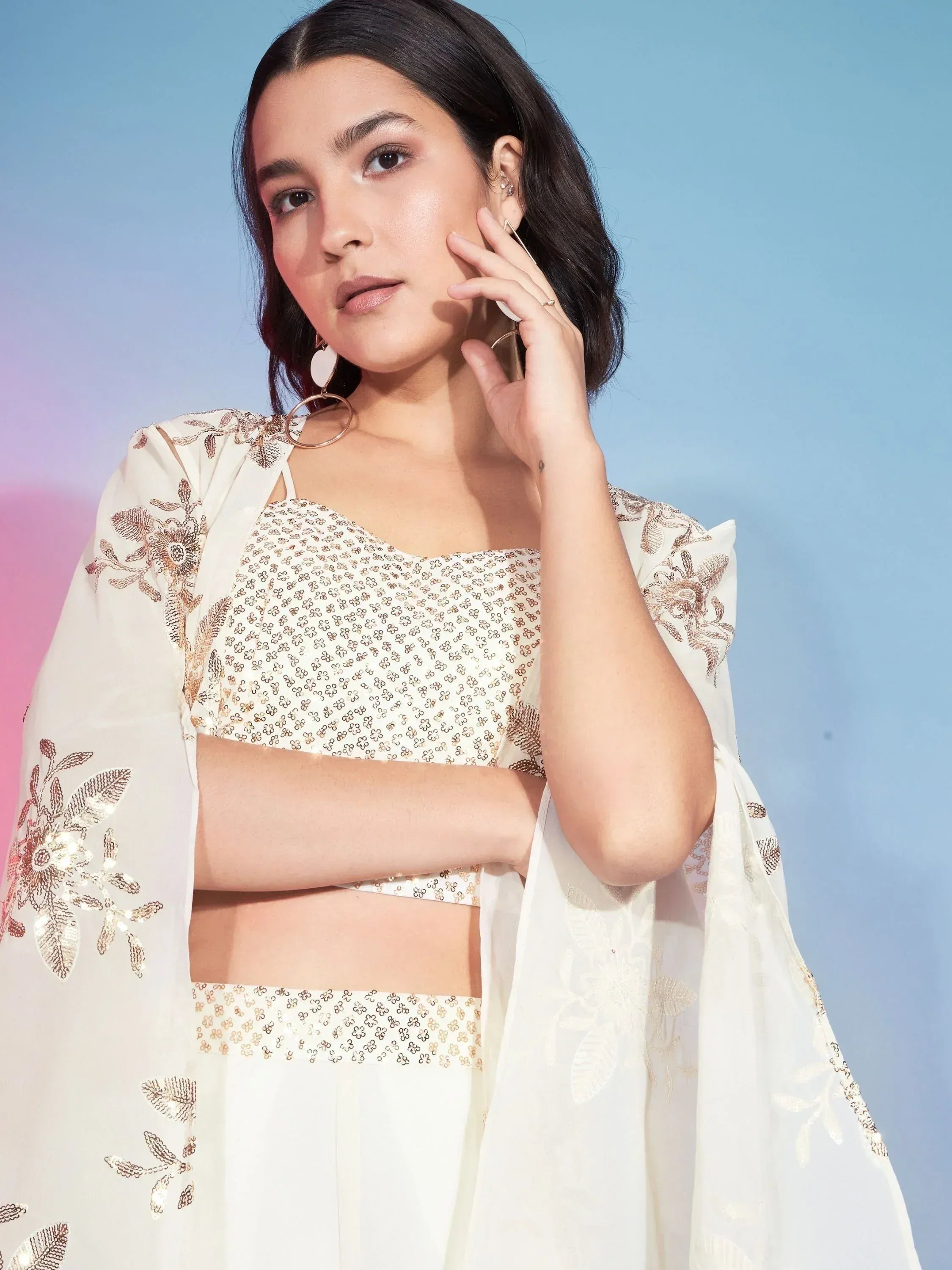 White embroidered lehenga choli with gold floral detailing, perfect for Indian ethnic wear occasions