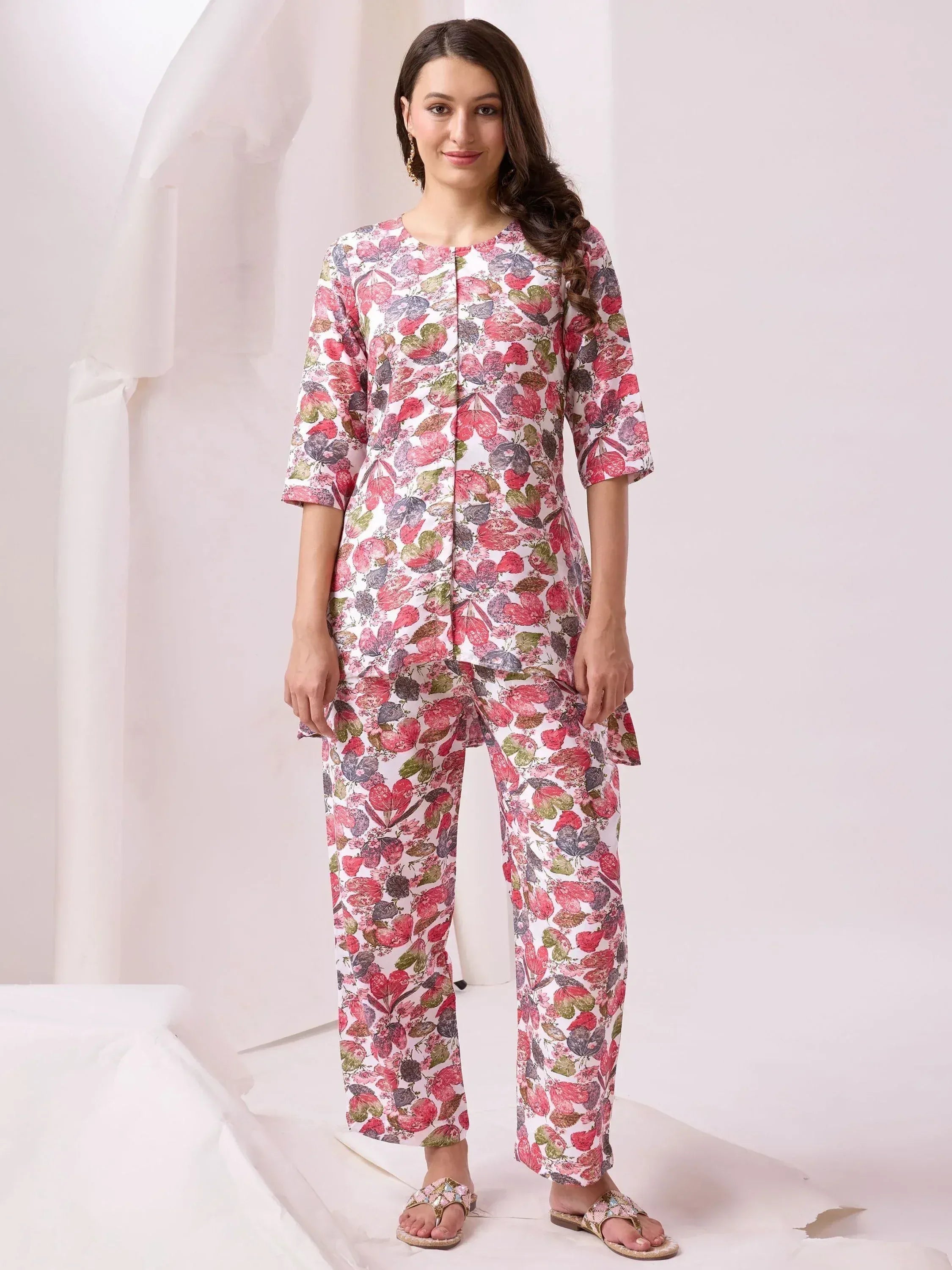 Floral print ethnic salwar kameez set with pink, green, and purple motifs on white fabric