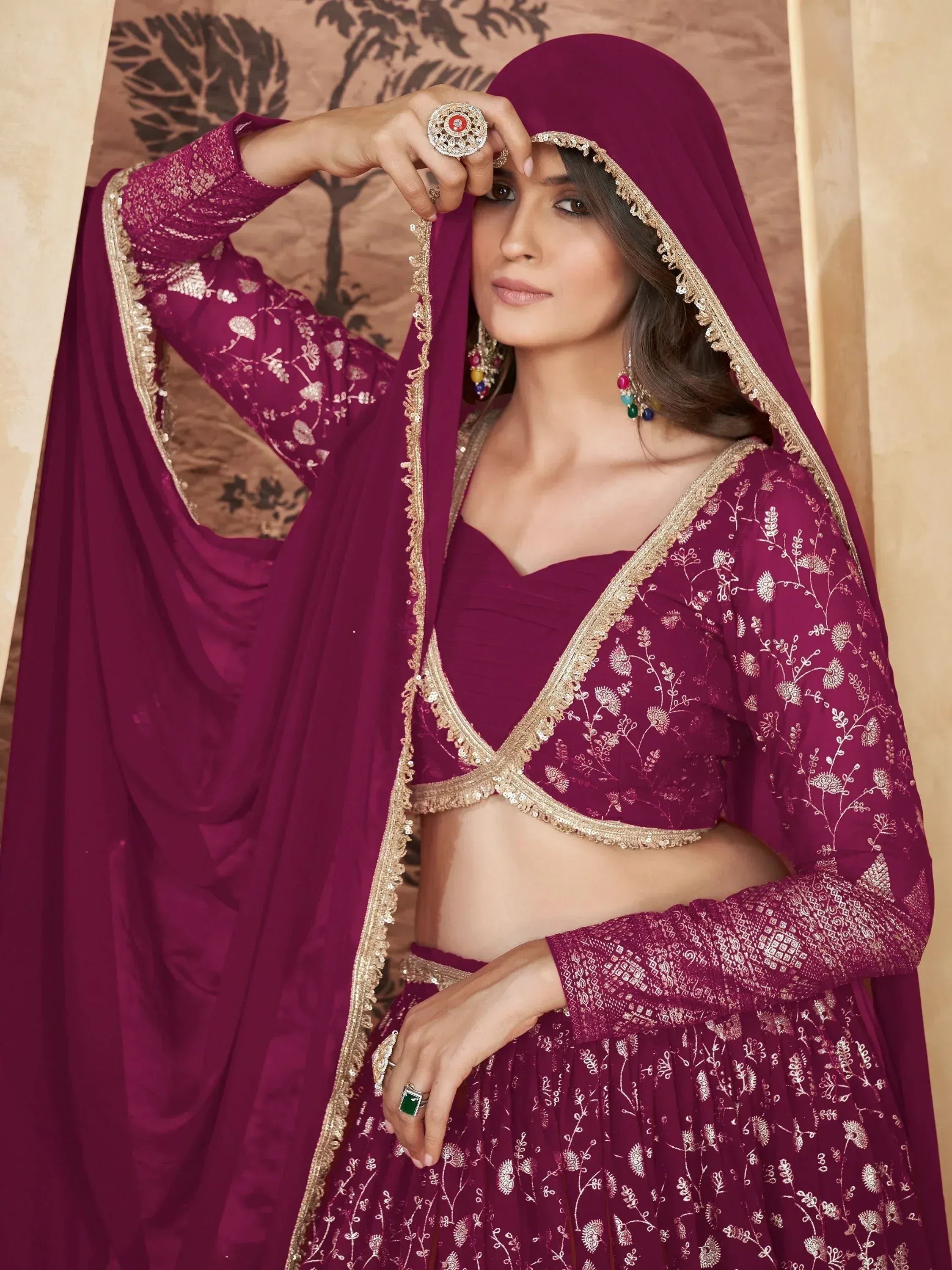 Elegant maroon lehenga choli with gold embroidery and dupatta, perfect for Indian ethnic wear occasions