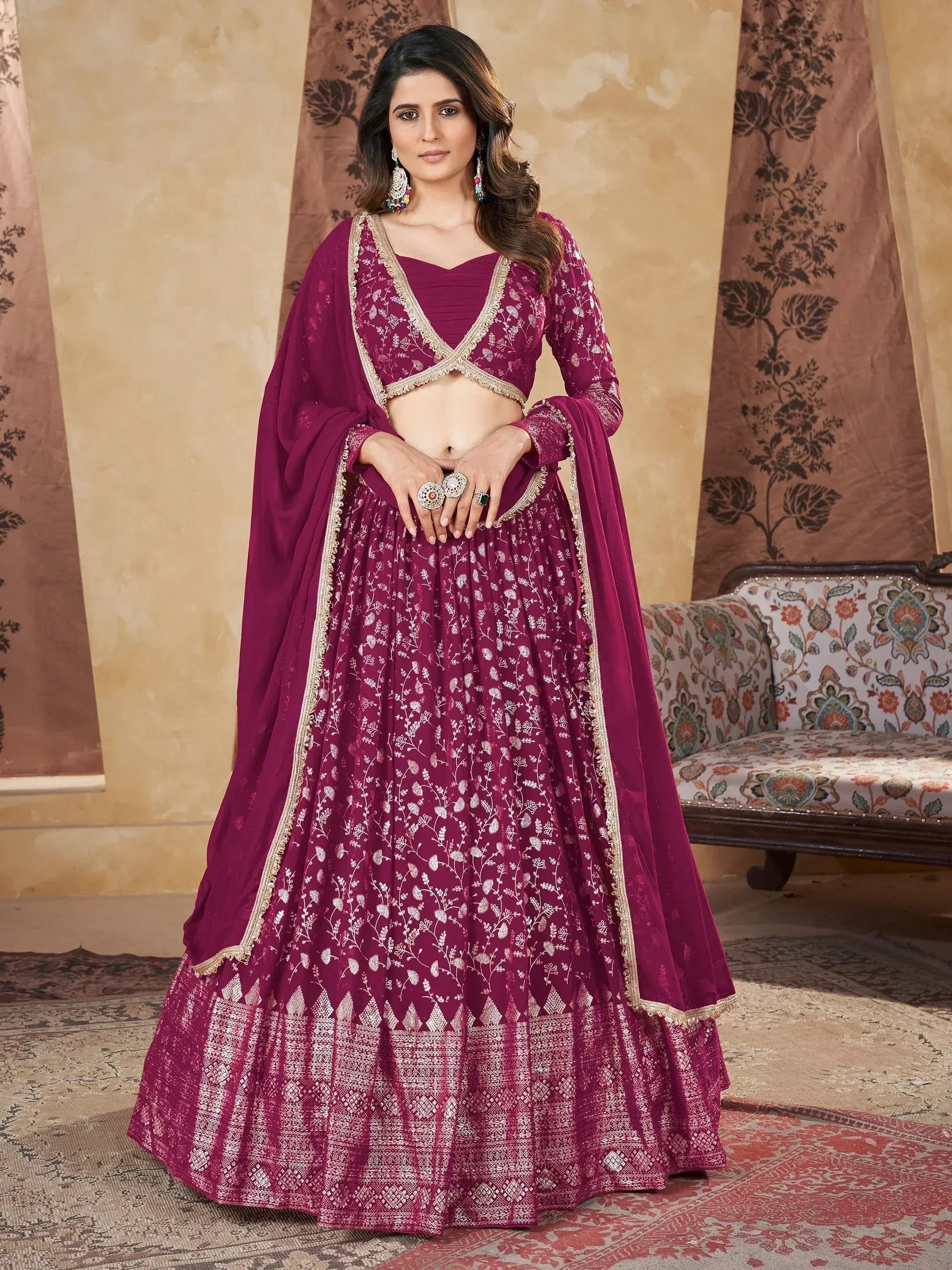 Elegant maroon lehenga choli with gold embroidery, perfect for Indian weddings and festive occasions.
