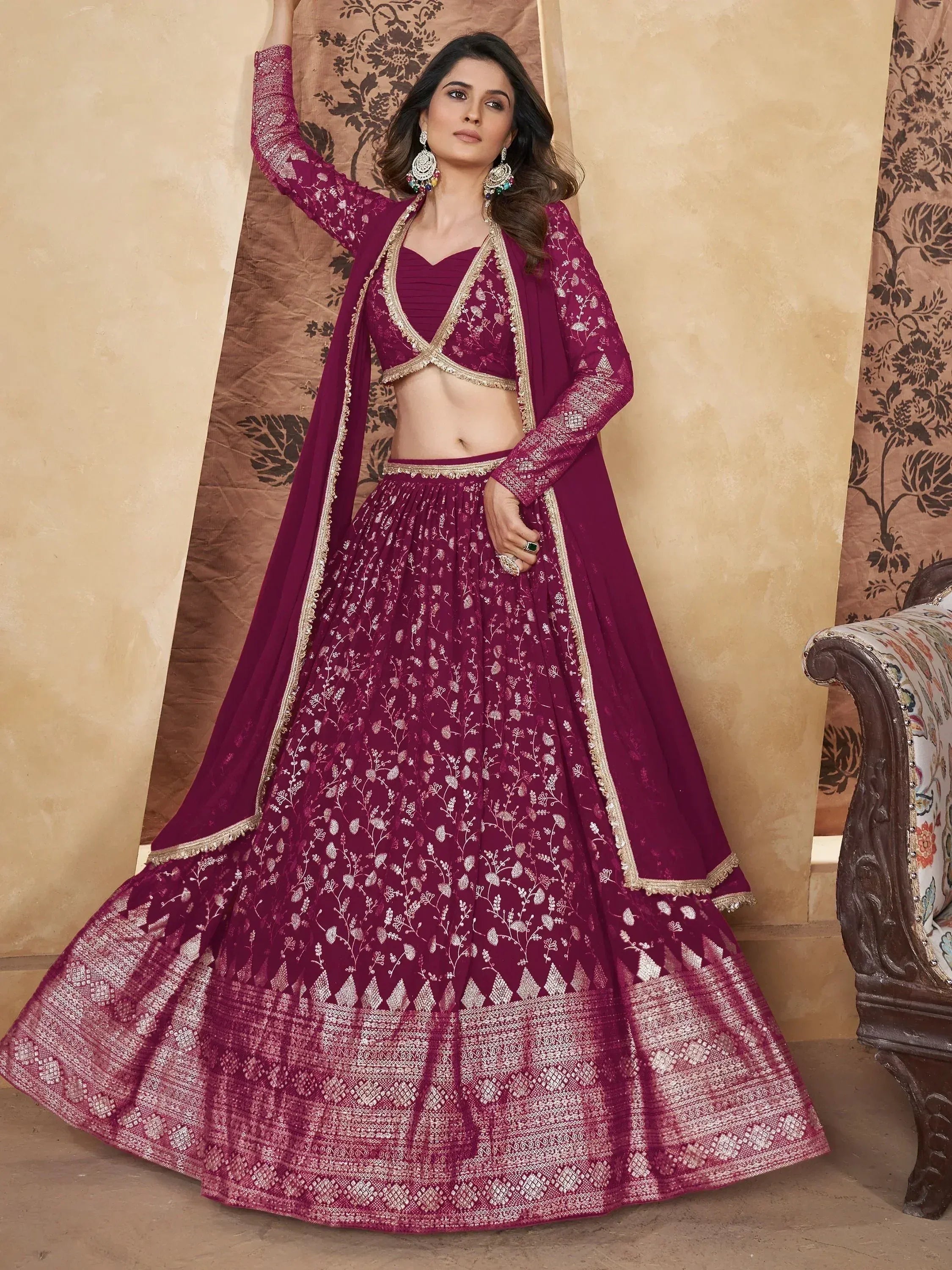 Elegant maroon lehenga choli with gold embroidery, perfect for Indian weddings and festive occasions.