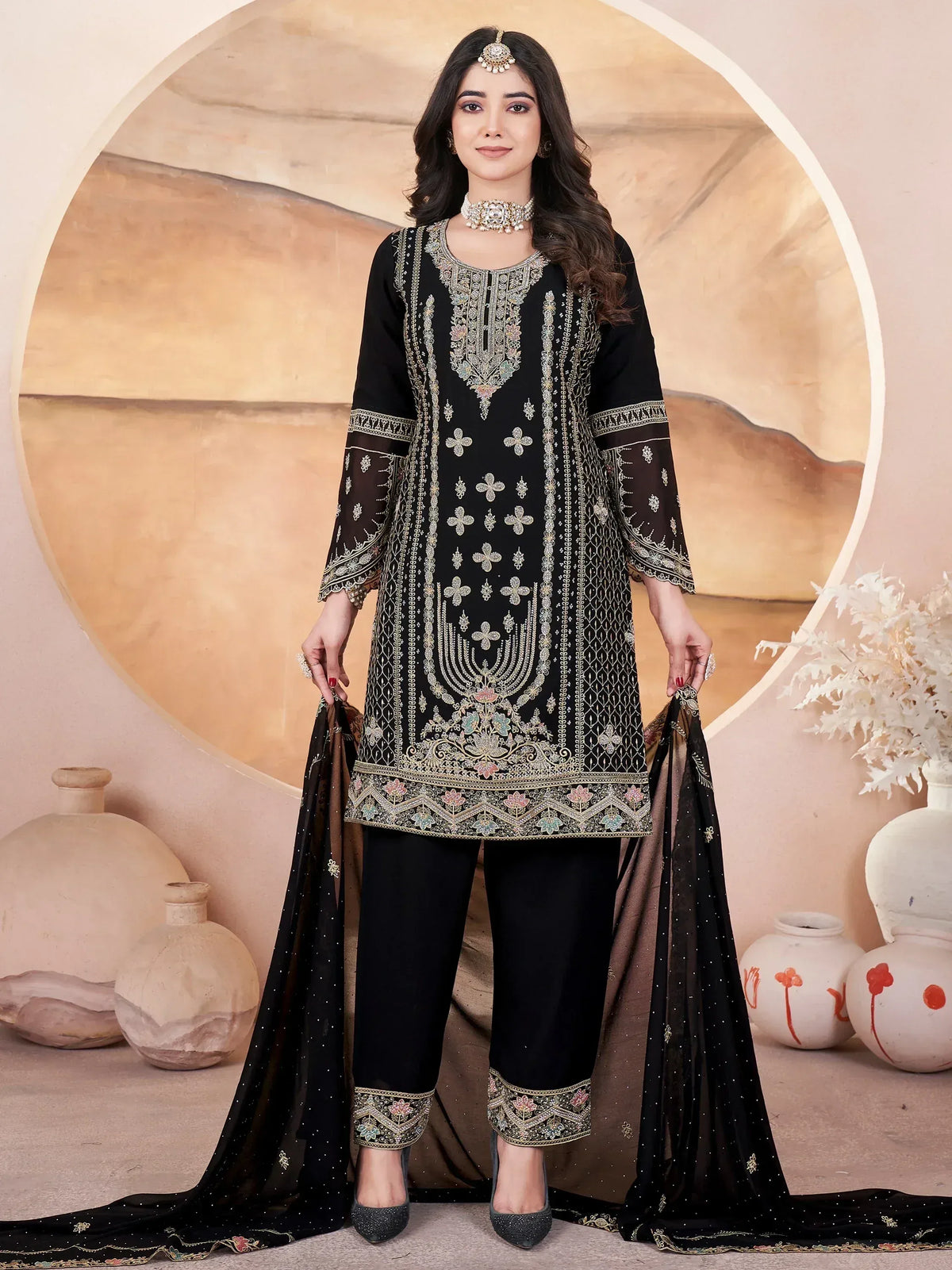 Black embroidered salwar kameez with gold detailing, perfect for Indian ethnic wear and festive occasions.