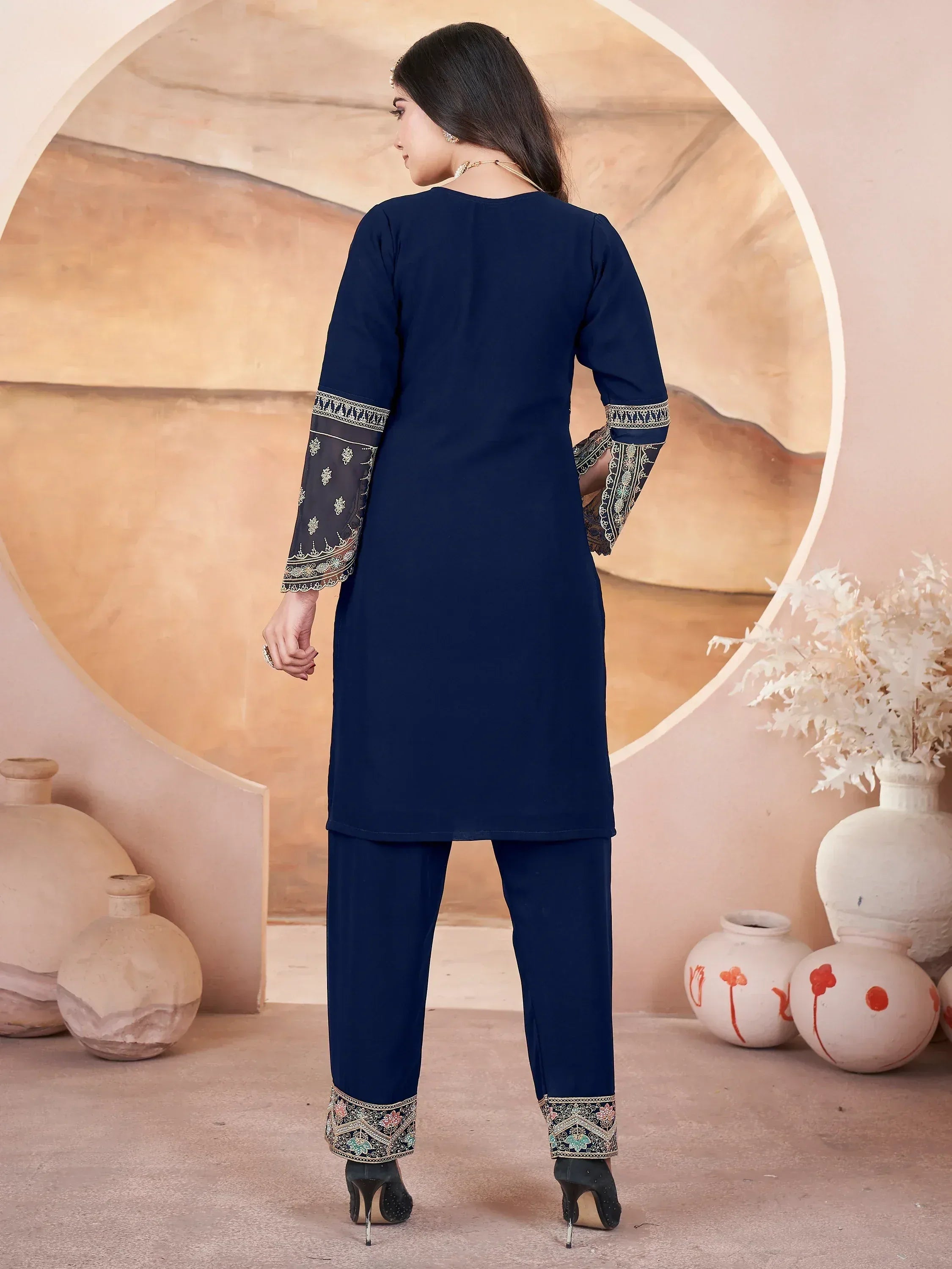 Navy blue embroidered salwar kameez with detailed sleeves and pants, perfect for ethnic wear occasions
