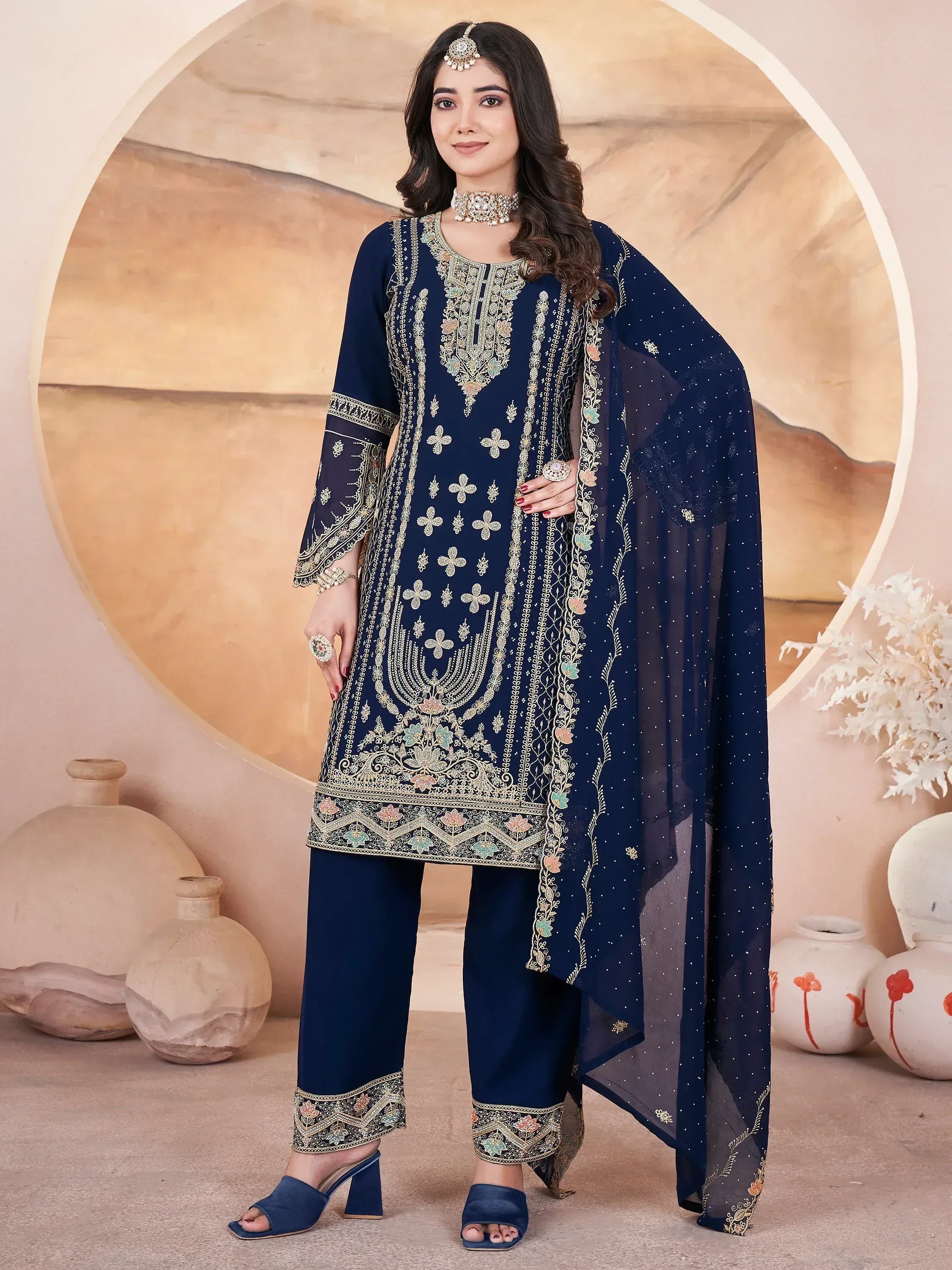 Navy blue embroidered salwar kameez with floral motifs and matching dupatta, ideal for Indian ethnic occasions