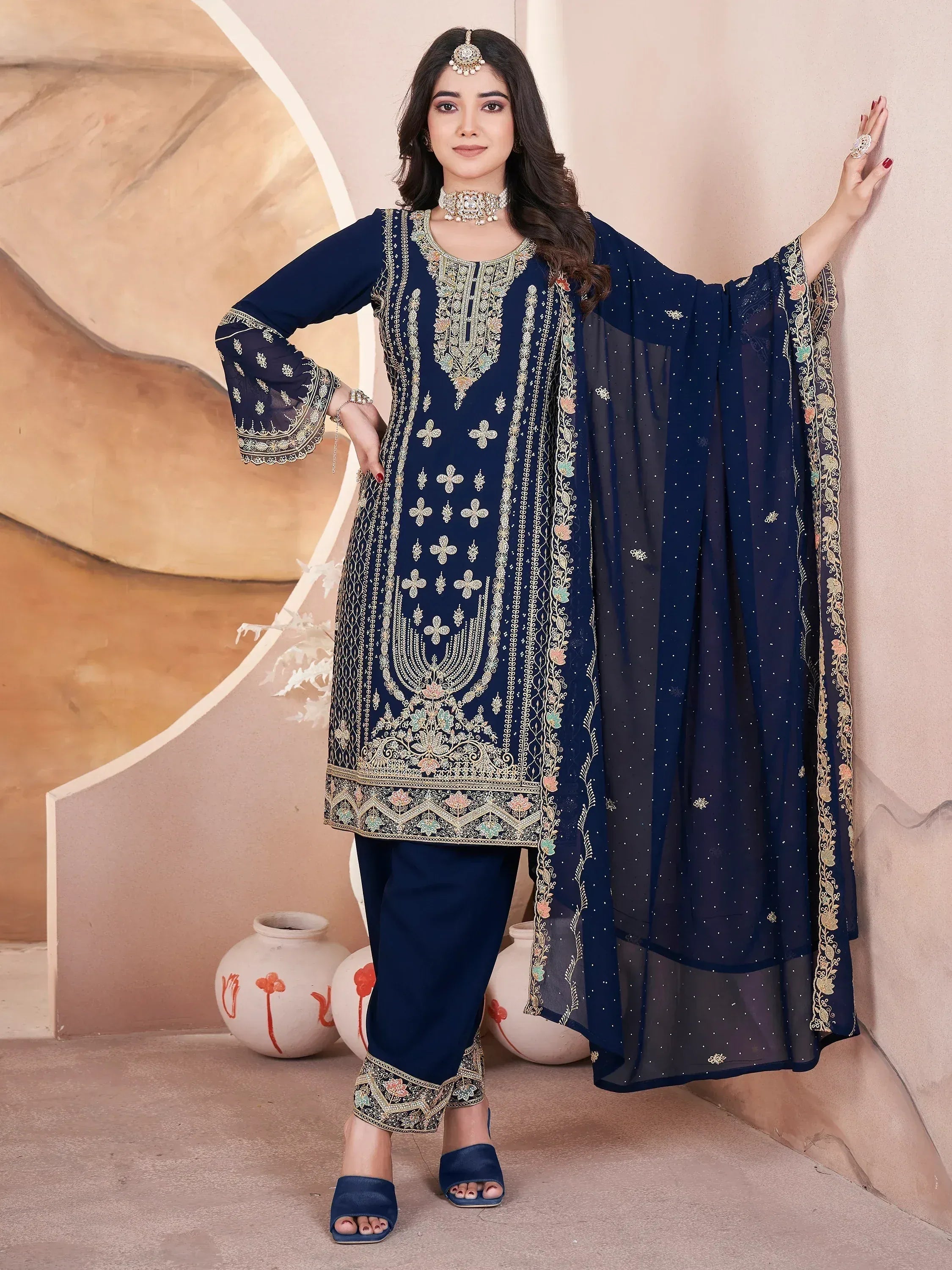 Navy blue embroidered salwar kameez with floral motifs, sheer dupatta, and matching pants for Indian ethnic wear