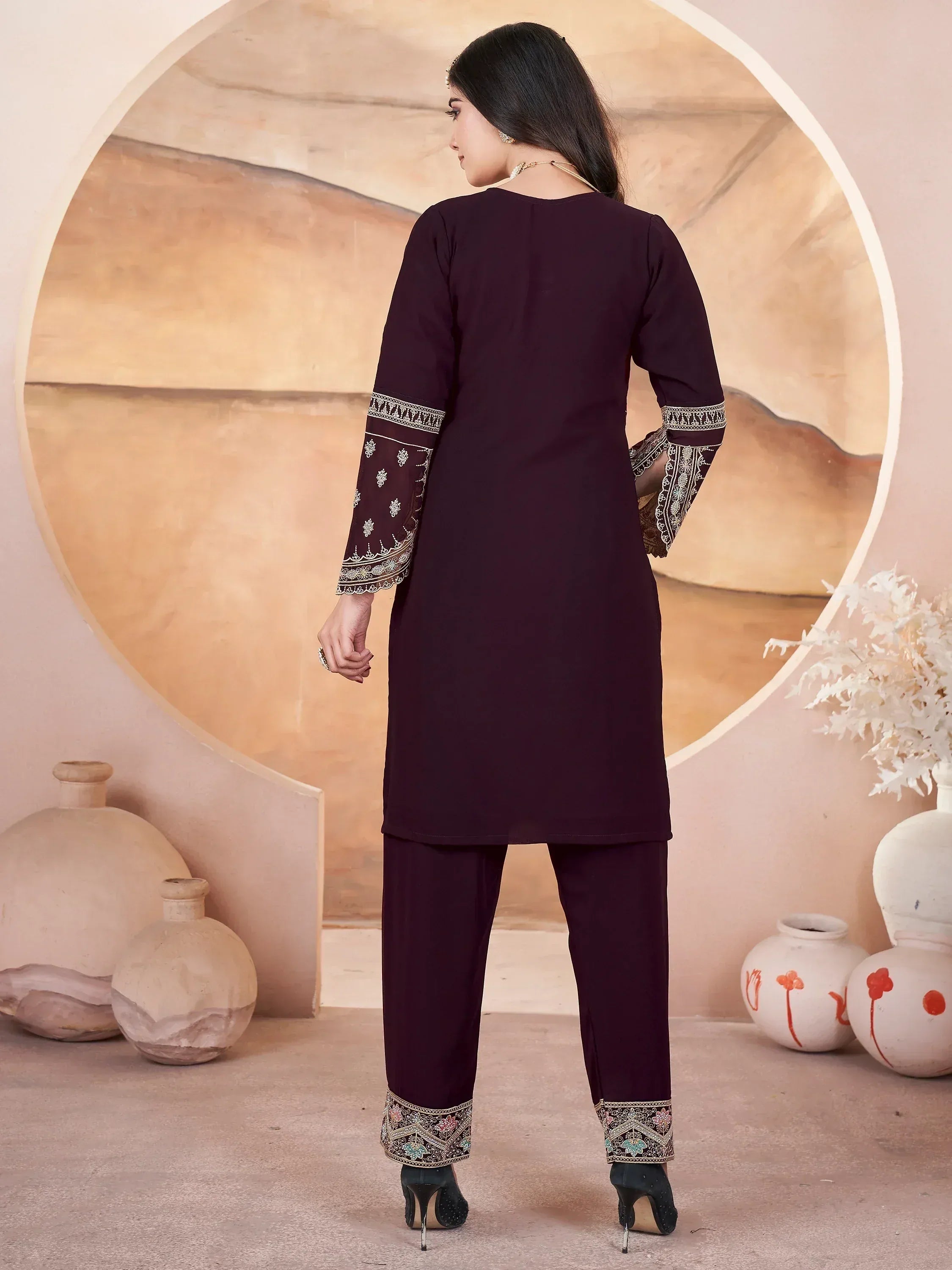 Elegant maroon salwar kameez with embroidered sleeves and pants, perfect for ethnic occasions.
