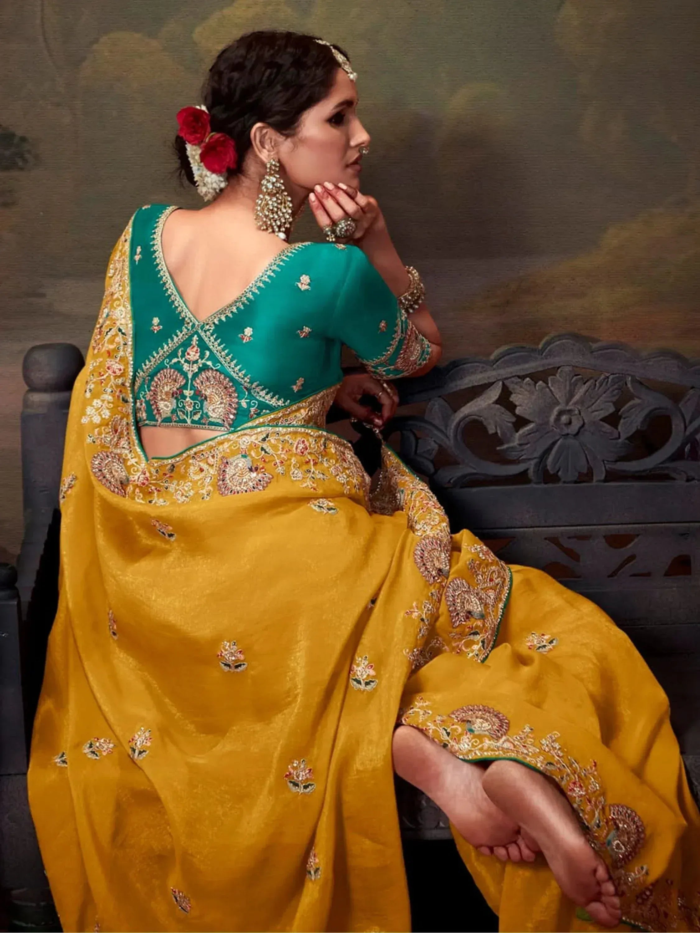 Elegant woman in mustard yellow saree with green embroidered blouse, traditional Indian ethnic wear